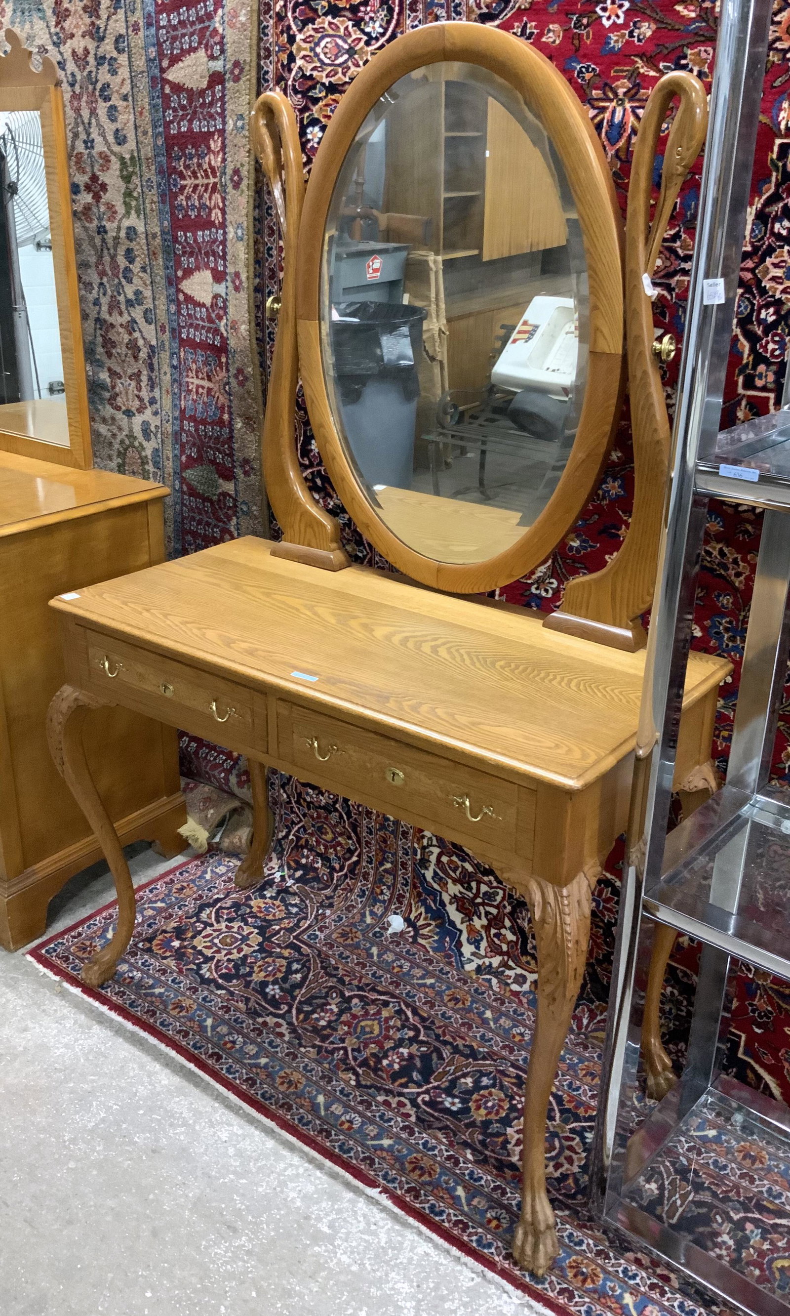 Carved Golden Oak Vanity with Oval Mirror.: The Mirror Harp has Swan Heads on either Side. The Mirror is Bevelled. It is in Excellent Refinished Condition. It measures 68" Tall, 42" Wide, and 19 3/4" Deep. Third-Party Freight Shipping or Person
