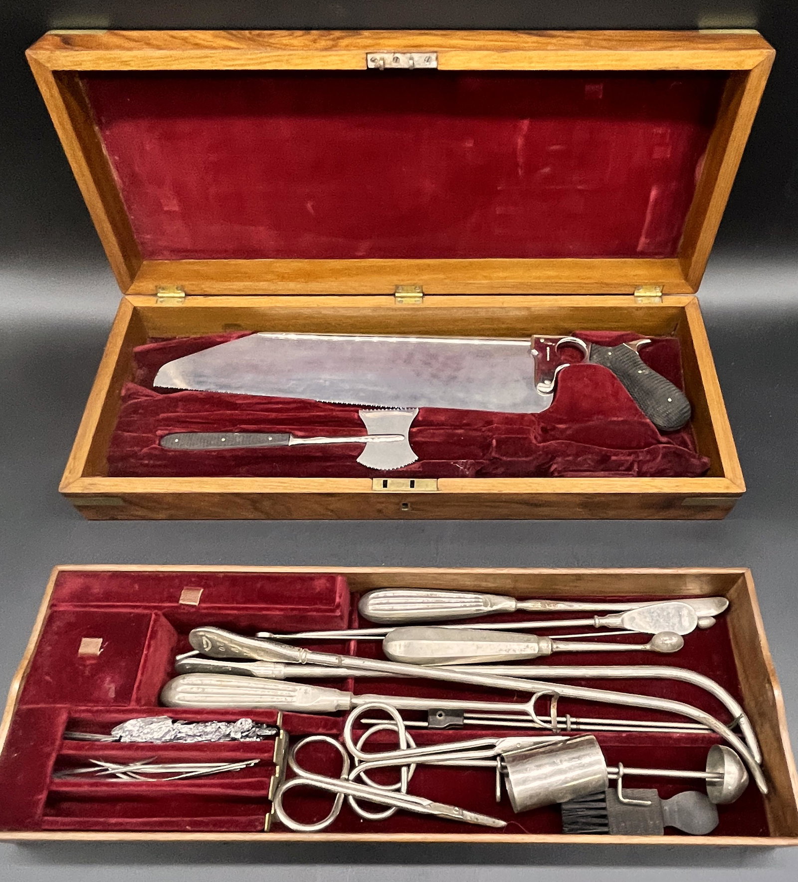 Antique Truax & Co. Surgeon's Kit in Rosewood Case: This Field Kit includes 10 pcs. miscellaneous doctor's tools, curved needles and 2 bone saws. Both saws are of the highest quality and made by C Truax & Company of Chicago IL. - The Rosewood Case is m