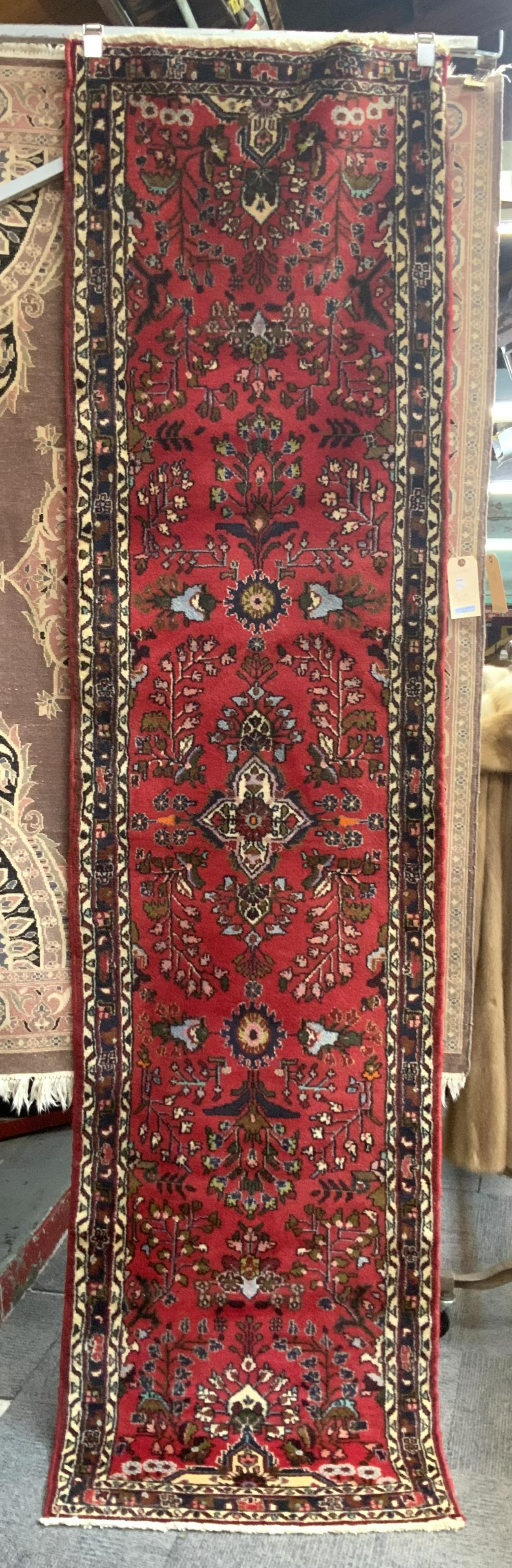 9' 8" X 2' 6" Handmade Hamedan Oriental Runner Rug: This runner has a red field with an all-over decoration and a darker border. There is a minor texture change at one end which is noticeable. There are no sign of damage or stains. In-House Shipping is