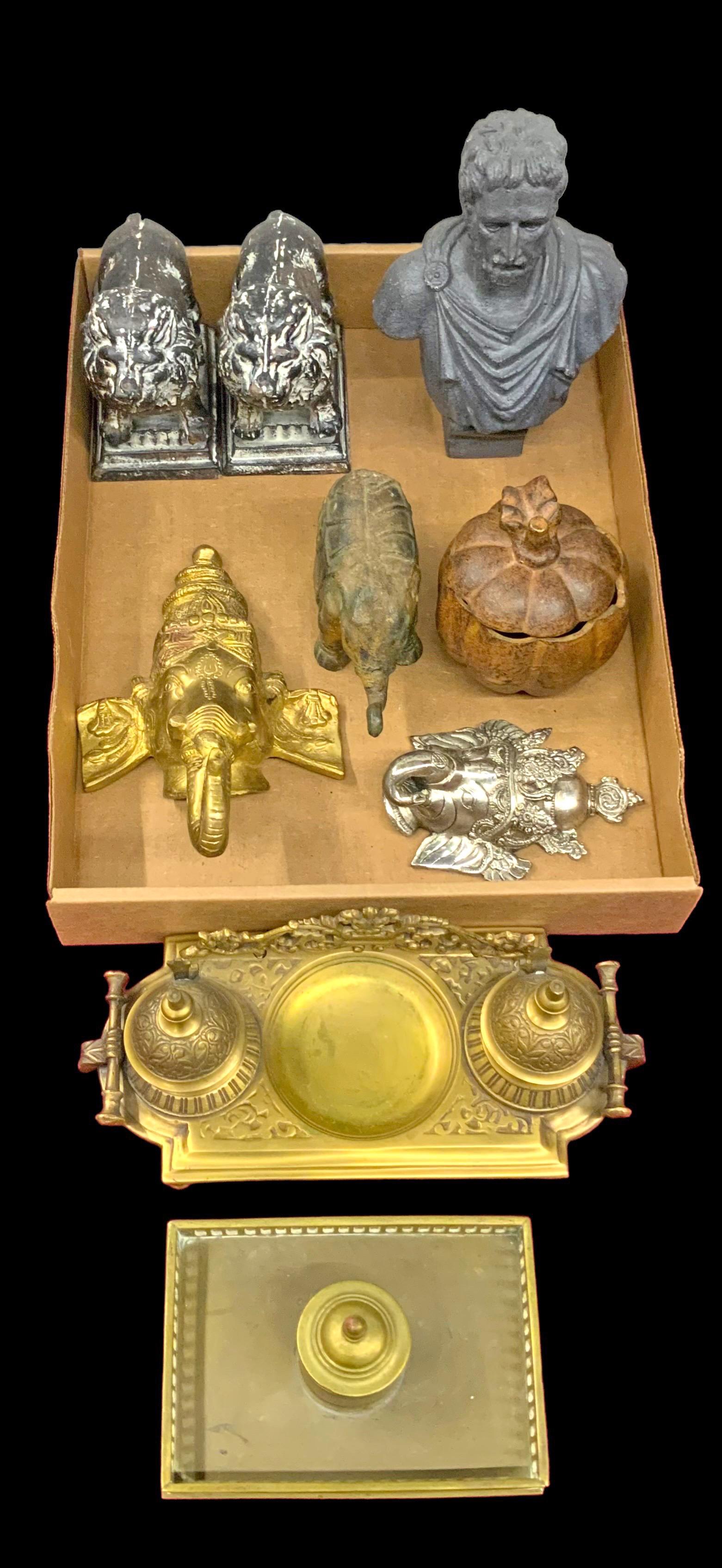 Lot: Two Brass or Bronze Inkwells, etc.: Also, a Small Bust, Ganesh Heads, a Cast Iron Elephant Figure, a Small Cast Iron Pumpkin, and a Pair of Iron Lion Figural Bookends. The Bust measures 8" Tall. Third-Party Shipping or Personal Pickup R