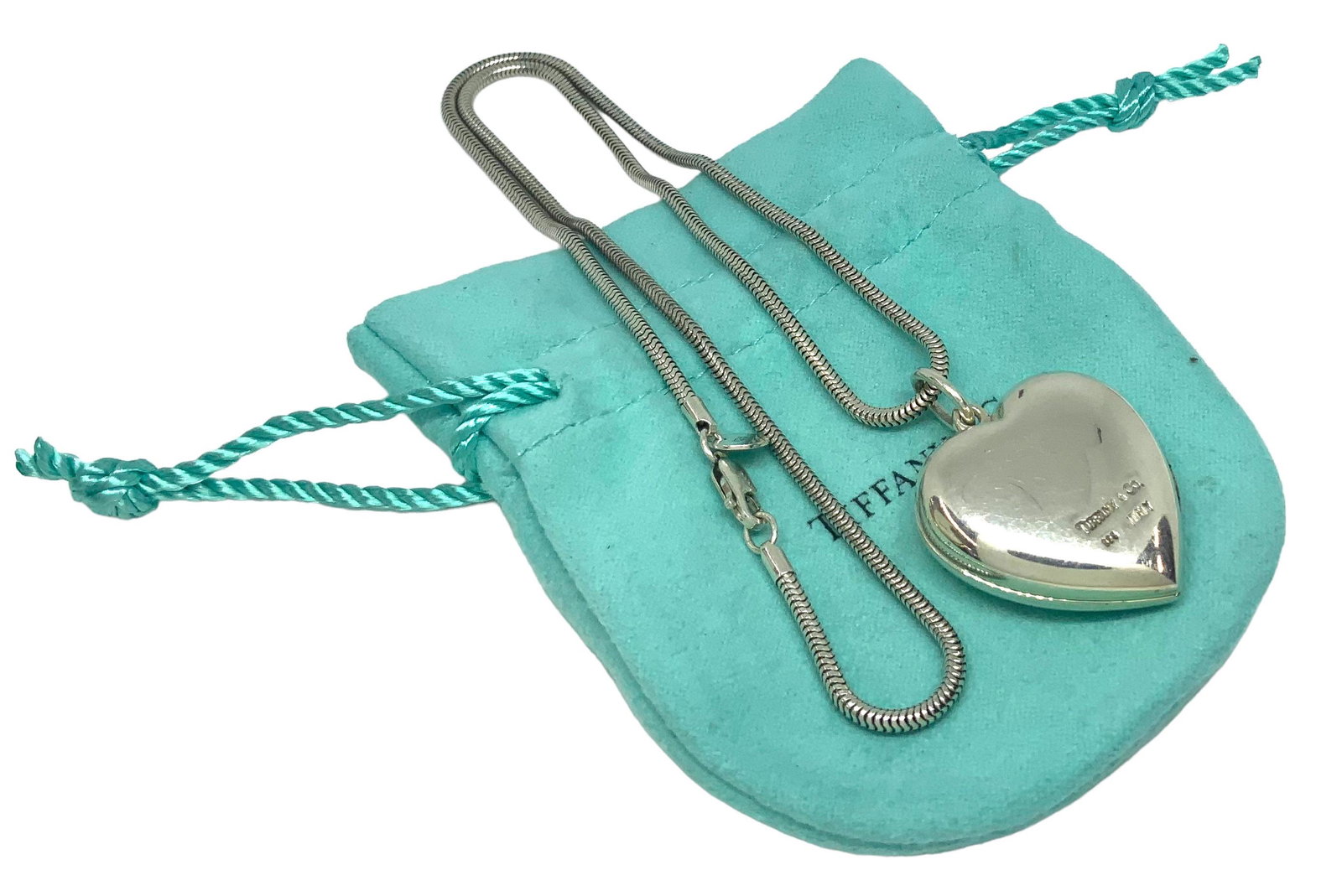 Sgd. Tiffany & Co. Sterling Heart Locket Necklace.: The Silver Heart Pendant is Signed, and the Sterling Necklace has a Tiffany Tag on it. The Heart Pendant has many Light Scratches on either Side of it. It measures approximately 1" x 1". The Chain mea