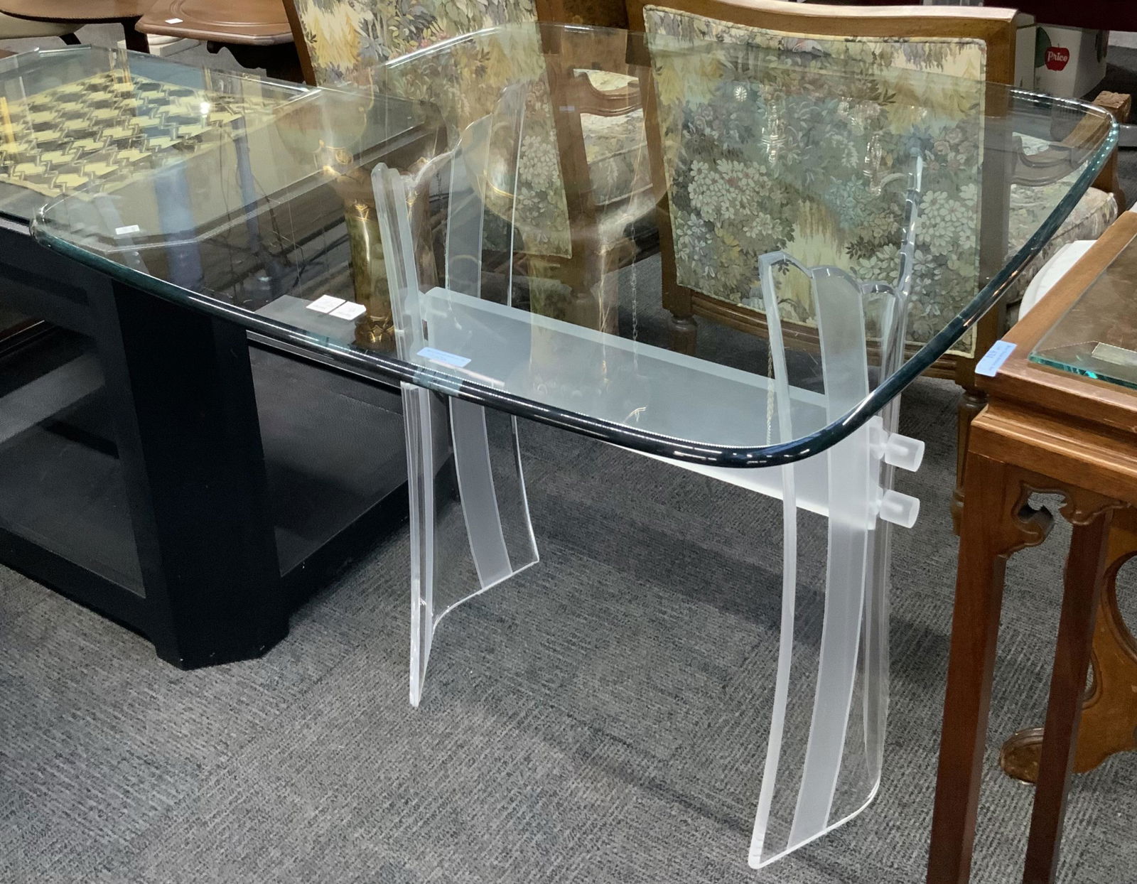 Modern Lucite or Acrylic Frosted Table.: This table has a curved and frosted base with a glass top. The piece is in good condition and shows no obvious signs of damage. it measures 29 1/2" tall, 36" deep, and 34 1/2" wide. Third-party freigh