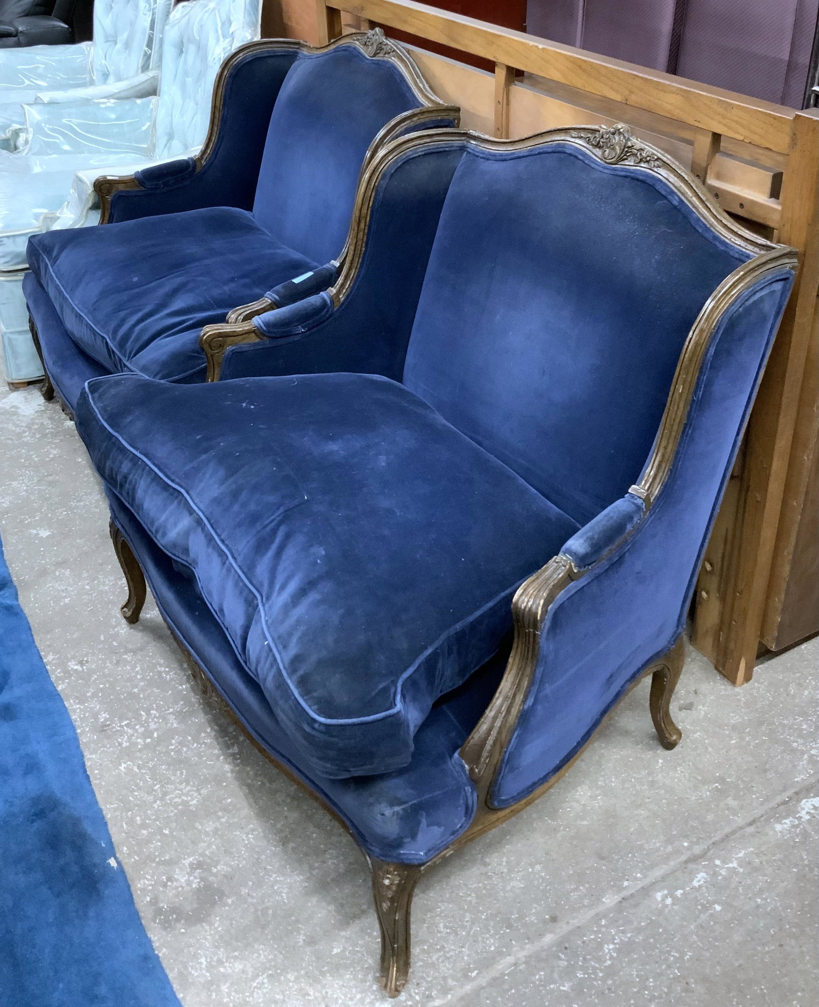 Pair of Bergere Chairs.: A Nicely Carved Pair of Blue French Bergere Chairs. They are not in Perfect Condition by any means, as they have some small food Stains on them, and there are a few dings on the Frame. They measure 36
