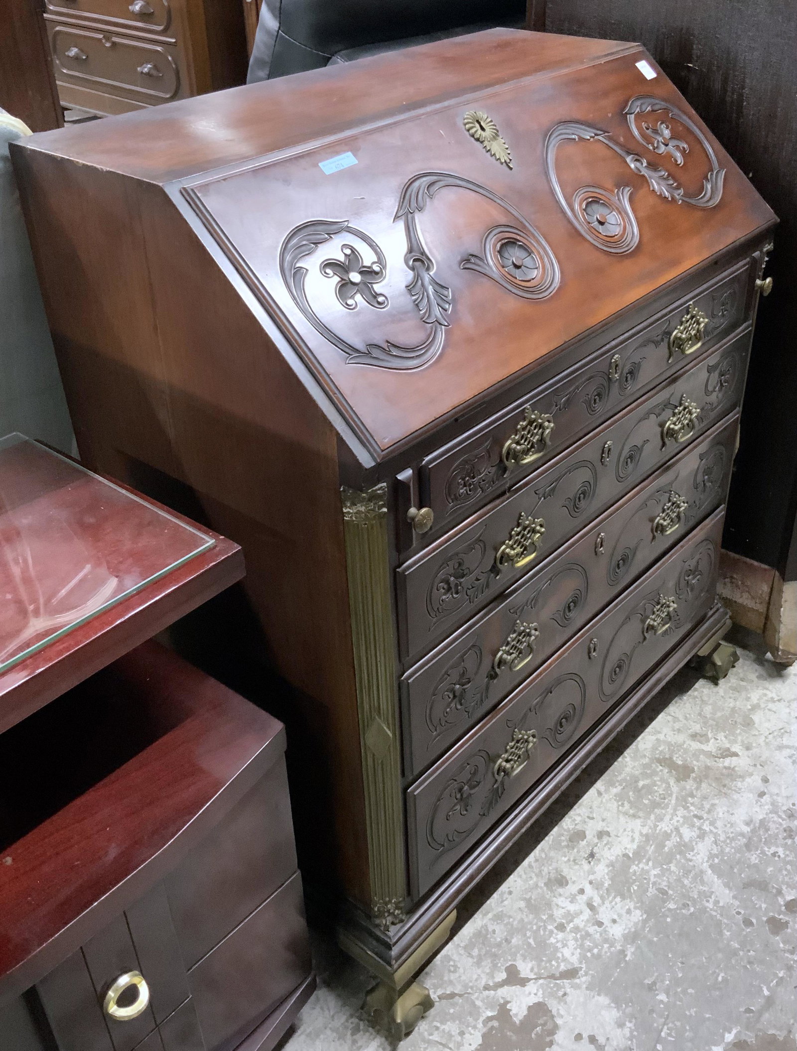 Chippendale-Style Mahogany Slantfront Desk.: This Desk has Bronze Column Sides and Bronze Claw Feet. The Front is Carved with the Original Hardware on all 4 Drawers. The Inside has Cubbyholes and Letter Holders. It is in Very Good Used Condition