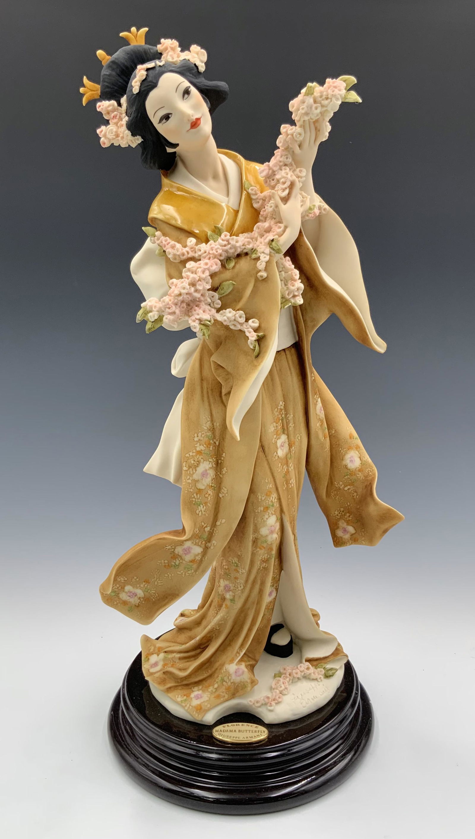 Giuseppe Armani "Madame Butterfly" Figure.: This is a Signed limited edition figurine. It measures 15 3/4" tall. The Figure has cherry blossoms in her arms and in her hair. Third-Party Shipping or Personal Pickup Required.