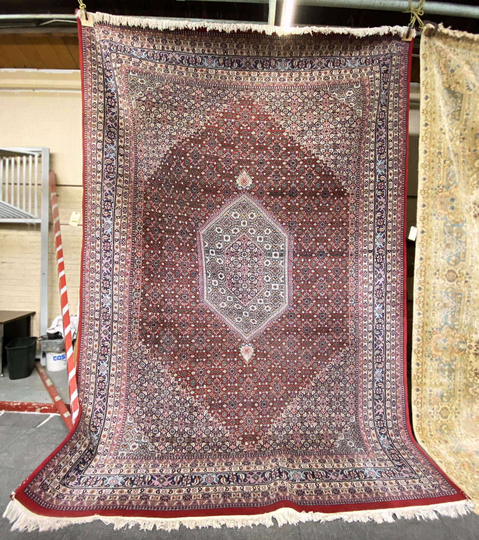 9' 9" x 13' 7" Red & Blue Bidjar Rug.: The Rug is in Overall Good Condition, with a few issues to the Piping on the Side. Third-Party Freight Shipping or Personal Pickup is Required.