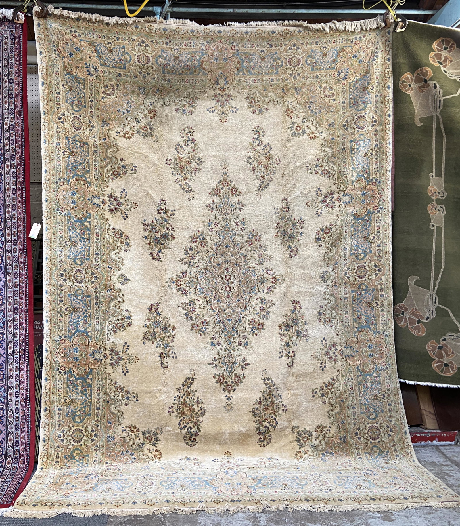 9' 10" x 13' 10" Ivory Kirman Rug.: The Rug could use some Cleaning, but is in Overall Good Condition. In-House Shipping is Available for this Rug.