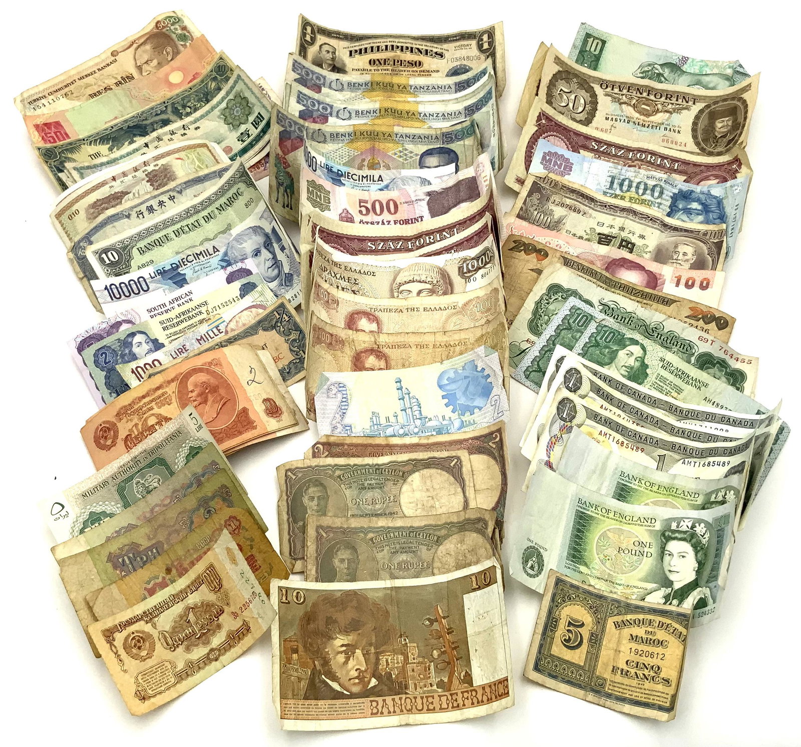 Lot of Older Foreign Currency.: Includes: Greek, Italian, Russian, Tanzanian, South African, Turkish, 2 English 1 Pound Notes, France, Tripoli, 3 Canadian $1 Notes, Chinese, Indian, Philippines, Japan, etc.- The Currency is not in G