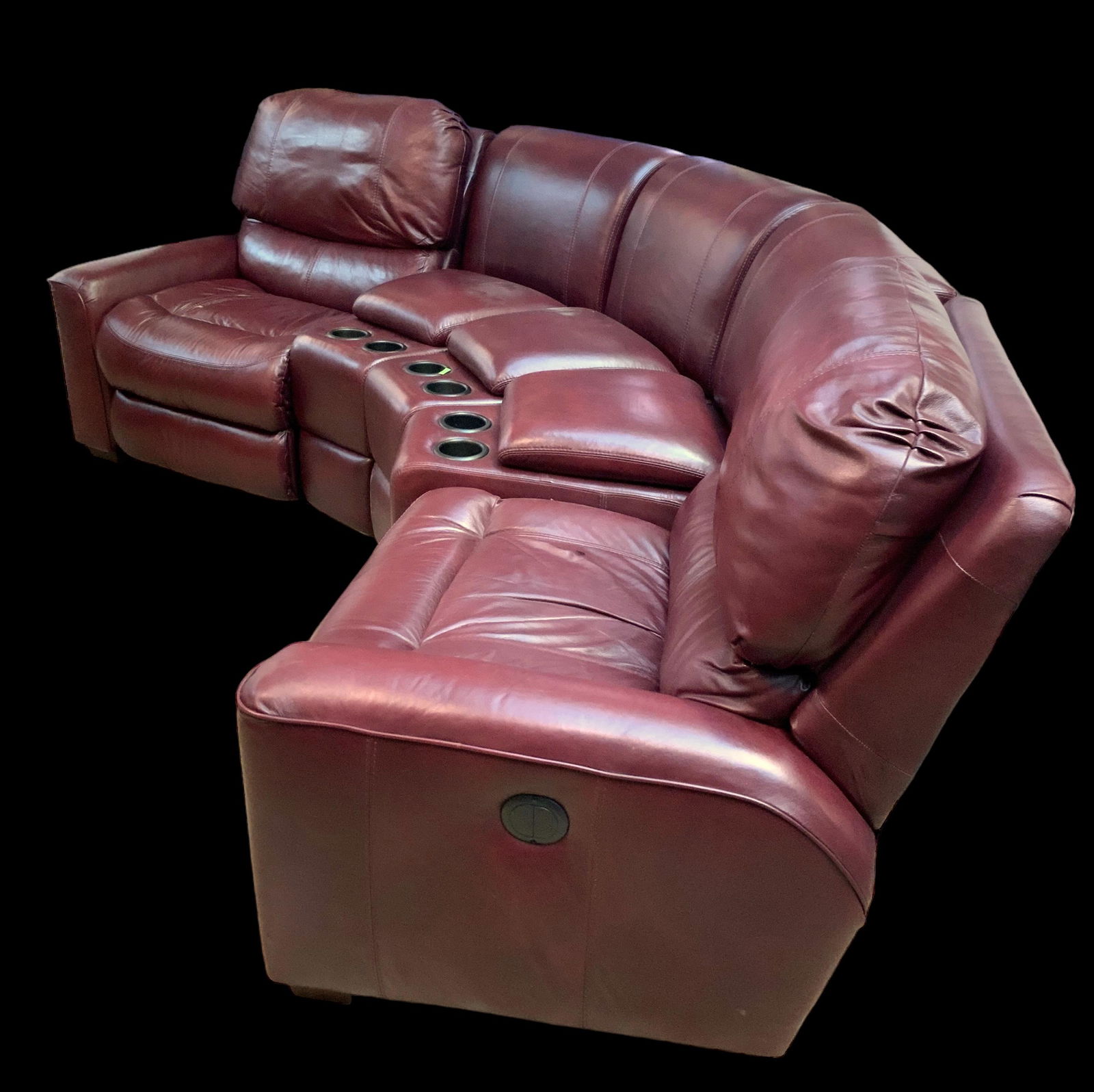 Burgundy Leather Sectional Reclining Sofa.: This lot consists of two matching armchairs and three matching center consoles. The consoles have a storage compartment, as well as two cupholders. The controls on the recliners are in working conditi