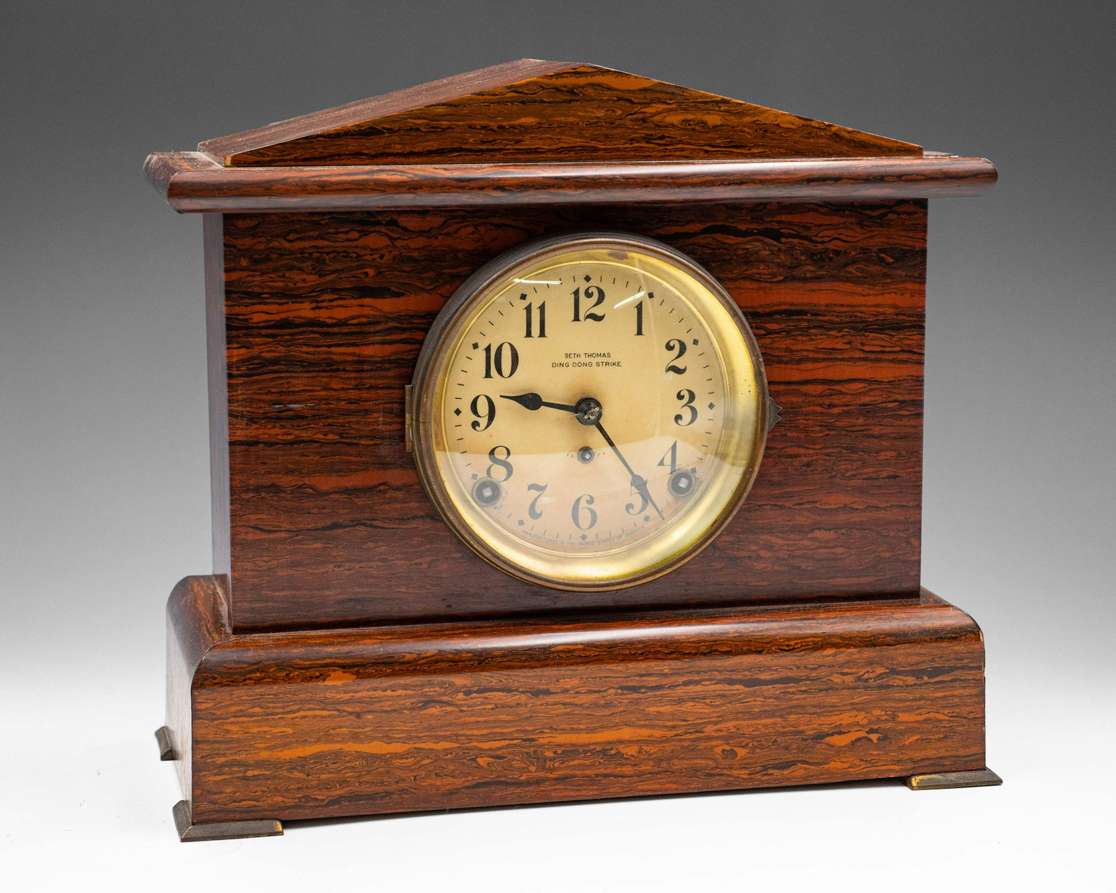 Seth Thomas Mantle Clock in Mission-Style Case.: The Clock face reads "Ding Dong Strike". The Clock appears to be intact, with minor chipping in the case toward the back. It is untested, and it winds in two places. The Key is missing, but the pendul