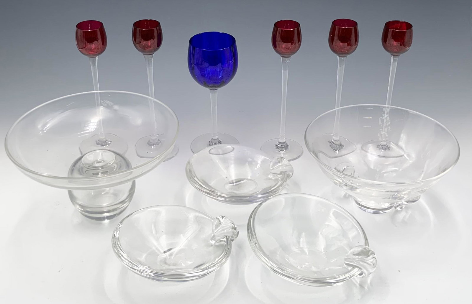 Mixed Lot of Signed and Unsigned Glassware.: A Mixed lot of glassware, including three pieces of signed Steuben serving dishes, one unsigned serving dish, one piece with engraved initials, one cobalt Baccarat wine glass, and 5 long stem 7 1/2" B