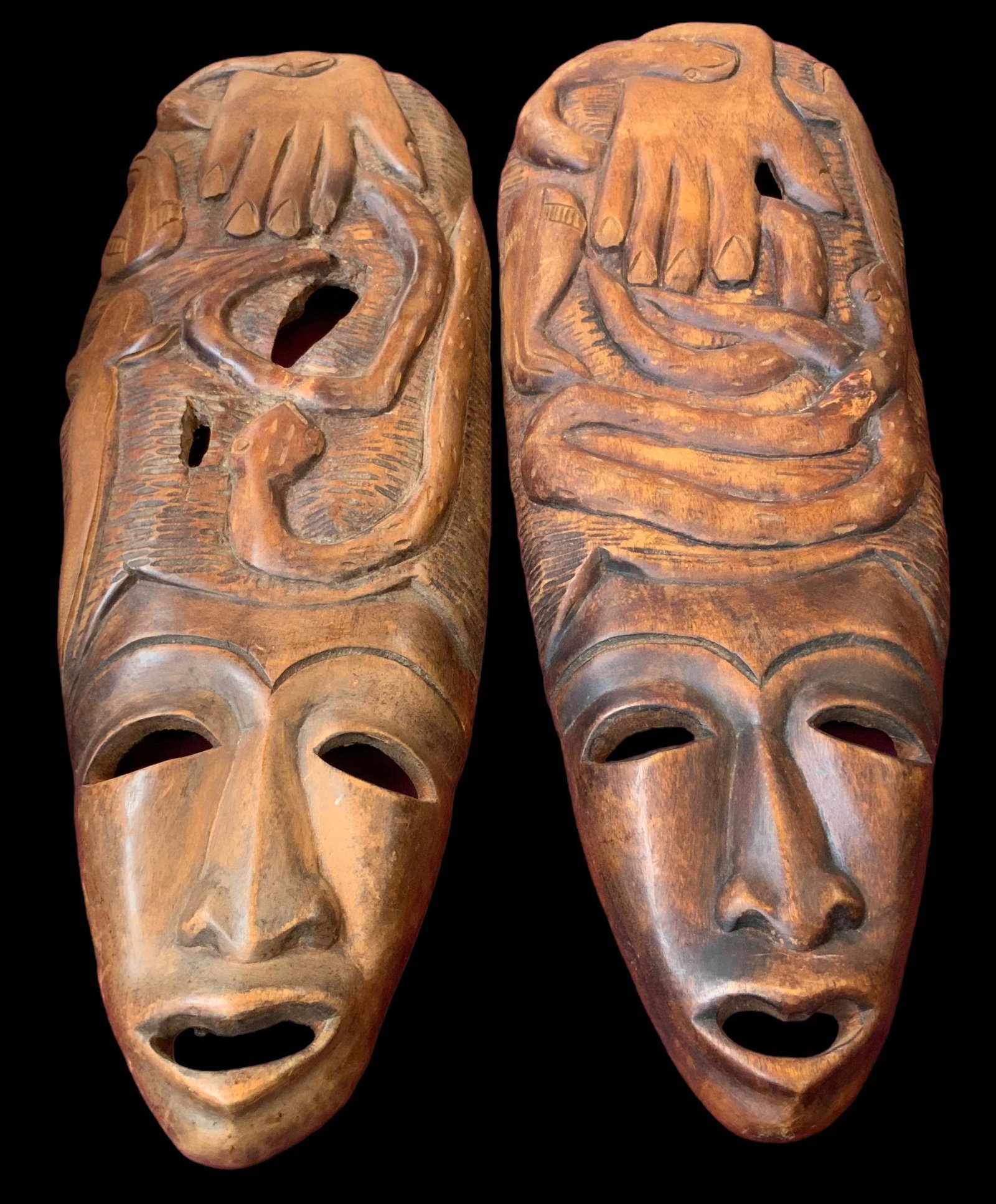 Pair of Carved Wood African? Masks.: These measure 24" Long, and have Hand and Snake Designs. In-house Shipping is Available. Please see our Website regarding in-house Shipping Procedures.