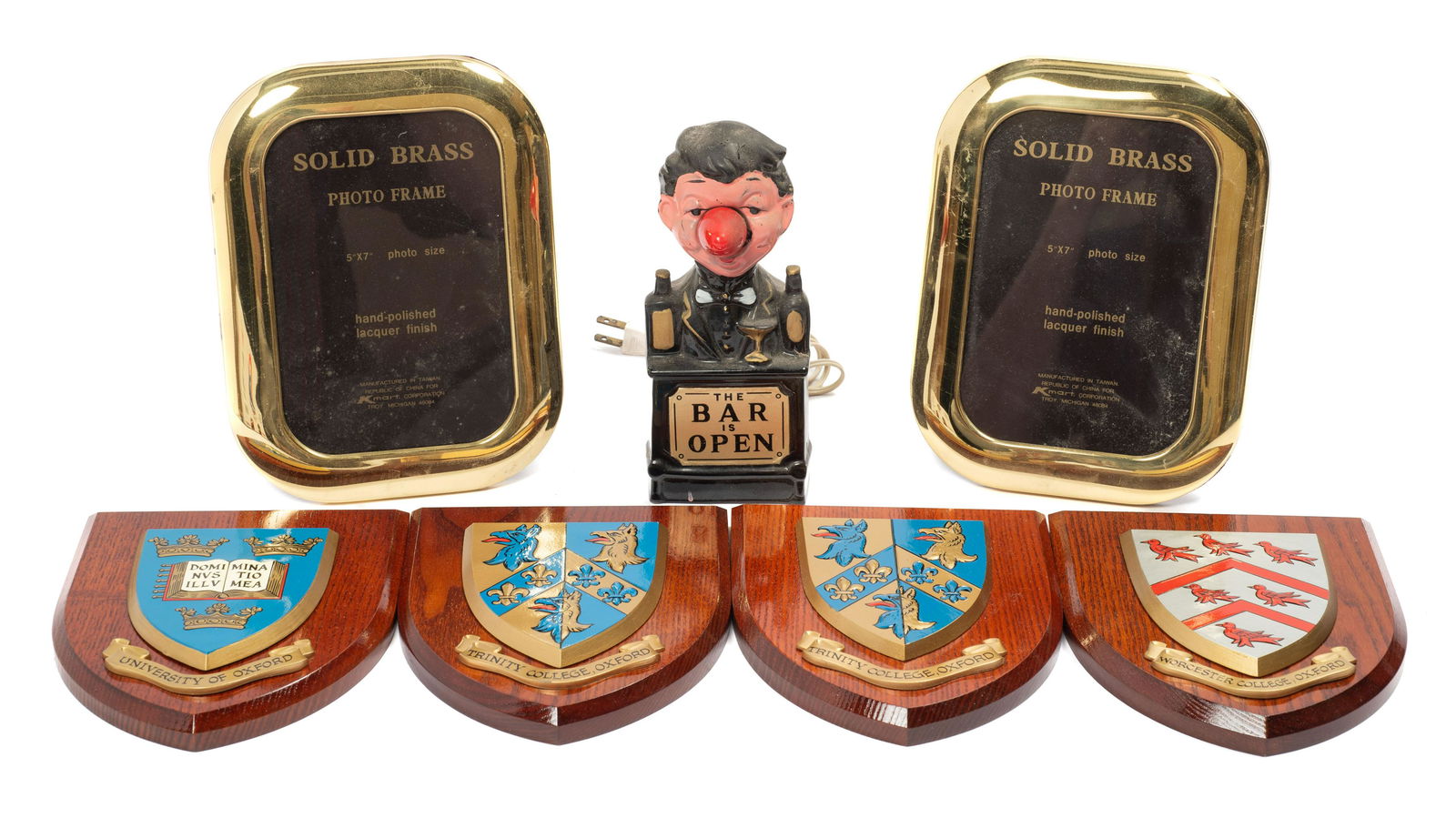 Lot: Oxford University Shields, Barman Lamp, etc.: The Oxford shields are 7" long, and come in their original boxes. The bartender lamp is made in Japan, and is Untested. There are also two brass picture frames. In-house Shipping is Available. Please