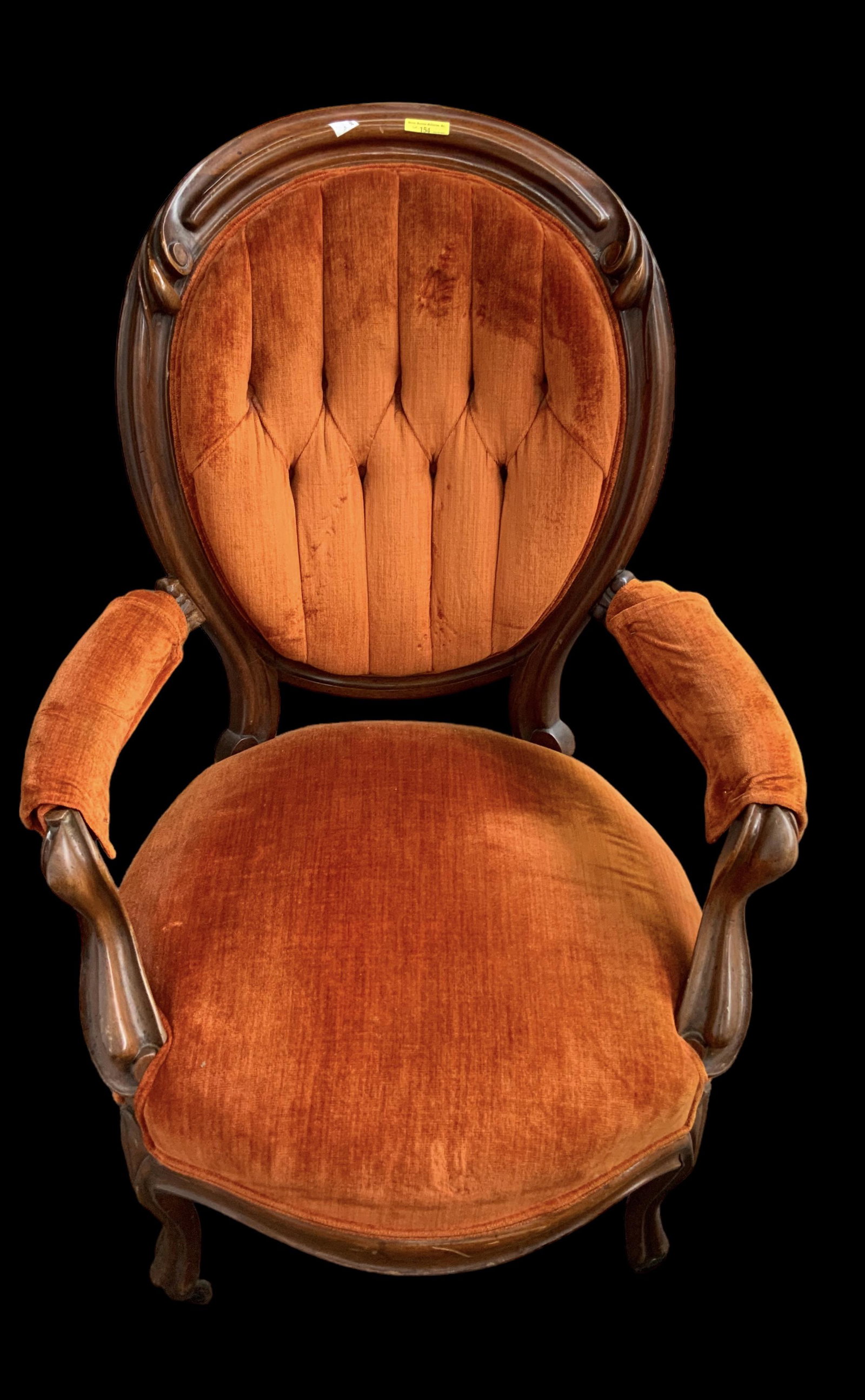 Victorian Carved Armchair w/ Rust Color Upholstery: The Chair is in Reasonably good condition for its age. There is an odd wear spot on the Upholstery where one's back rests. It measures 40" Tall, 28" Wide, and 31" Deep. Third-party freight shipping or