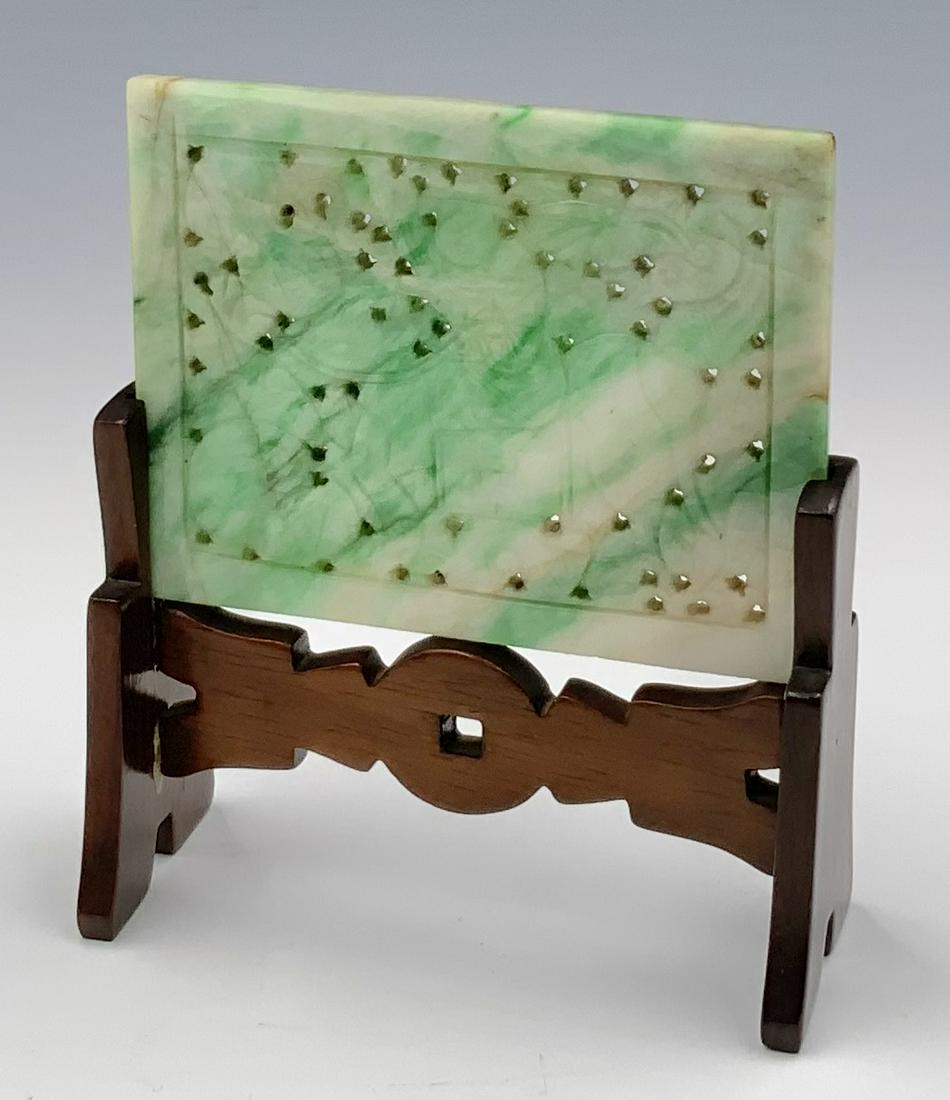 Small Chinese Carved Jadeite Plaque with Stand.: The Plaque has a Carved Image of a Man on a Horse. It measures 2 1/4" x 2 3/4". The wooden stand is simple, and comes apart easily, held together by one peg on either side. In-House Shipping is Availa