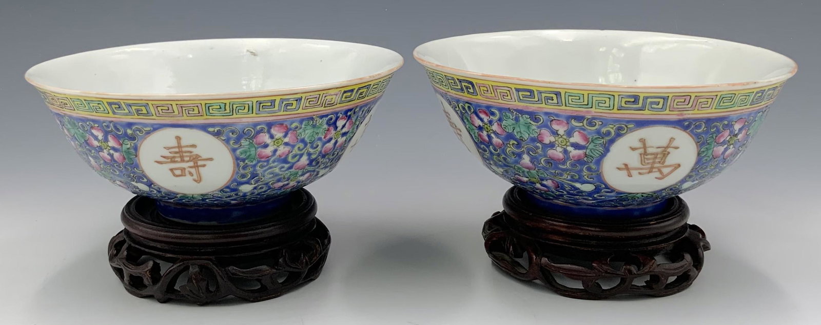 Pair of Two Chinese Porcelain Bowls with Stands.: The Interior of the Bowls are Painted with a Longevity Symbol and 5 Bats. One of the Bowls has a Hairline Crack on the Bottom (See Photo) It also has a Nick along its Rim. The other Bowl is in Good Ov