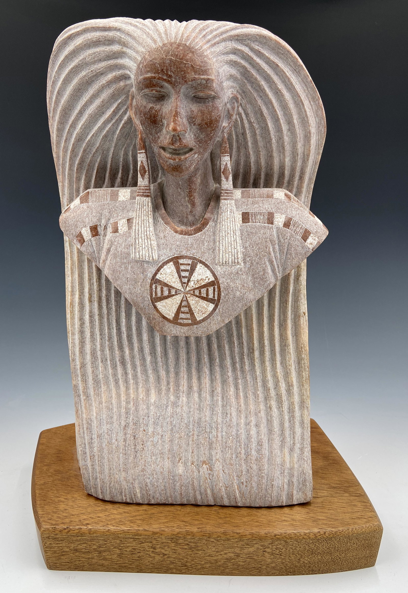 Clifford Fragua Bust of American Indian Woman.: The Stone bust is Signed and dated 1988. A wood base is attached. It looks to be in Very Nice condition, Measuring 17" tall, 12" long, and 7" deep. The bust is very heavy. Third-Party Shipping or Pers