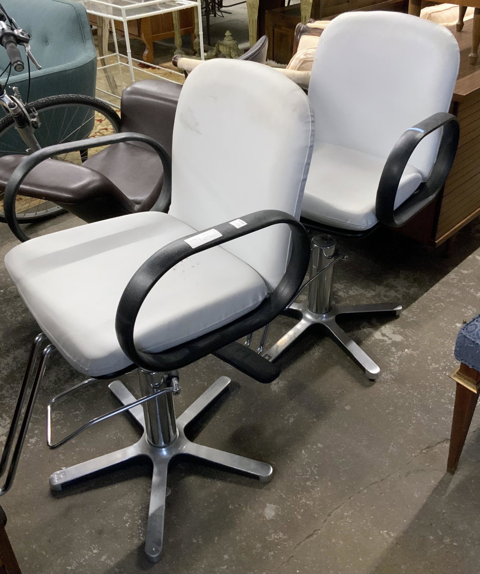 Pair of Stylist's Chairs or Barber Chairs.: These are Contemporary. They measure 22" Wide and 33" Deep. The height is Variable. Third-party freight shipping or personal pickup is required. Please see our website for our shipping recommendations
