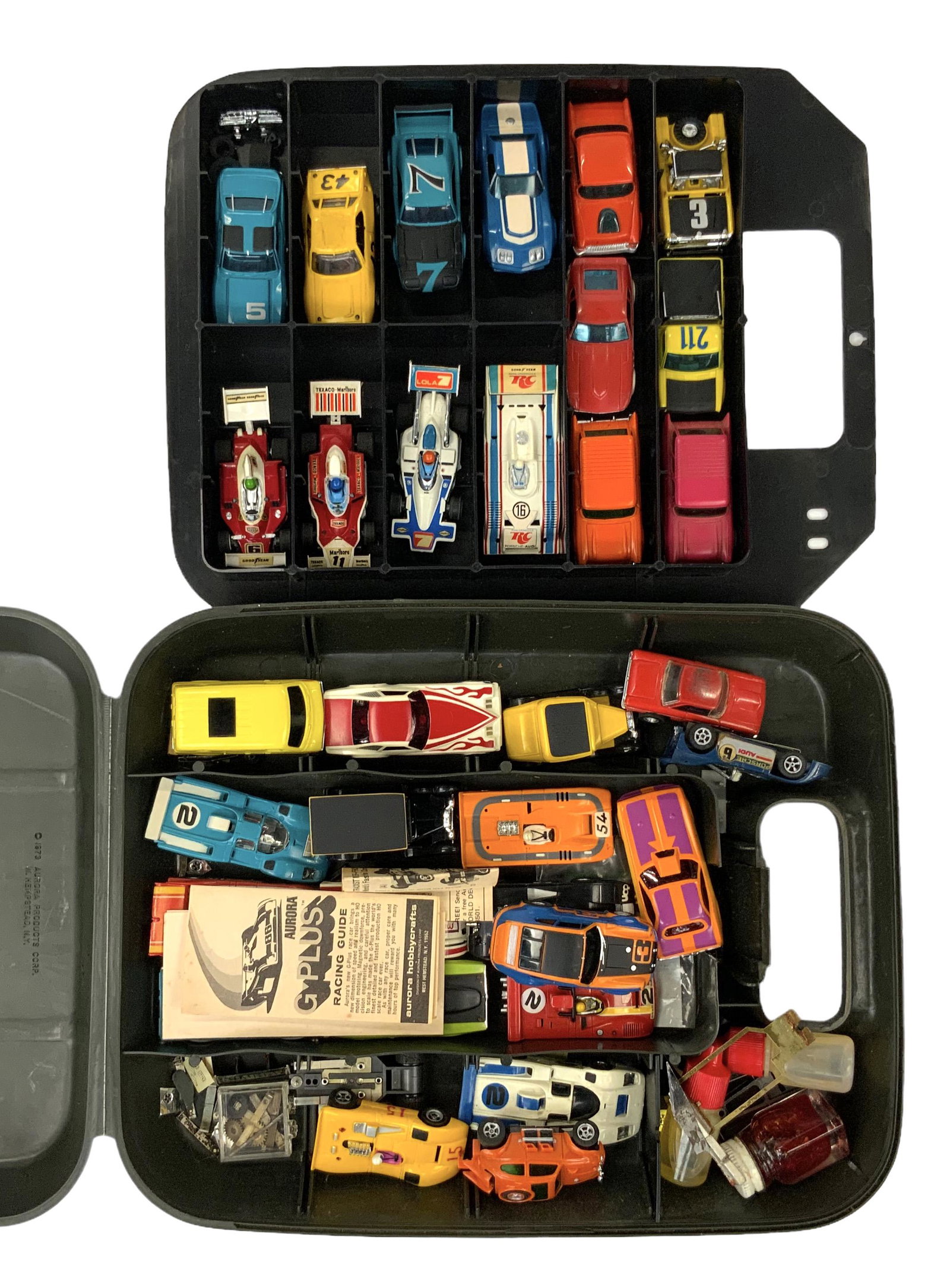 Lot of Vintage Slot Cars w/ AFX Race Case.: There are 33 race cars total, as well as some car parts. The cars are by Aurora G Plus and AFX. Overall, they look to be in Good condition. There are also a few paper guides. In-House Shipping is Avai