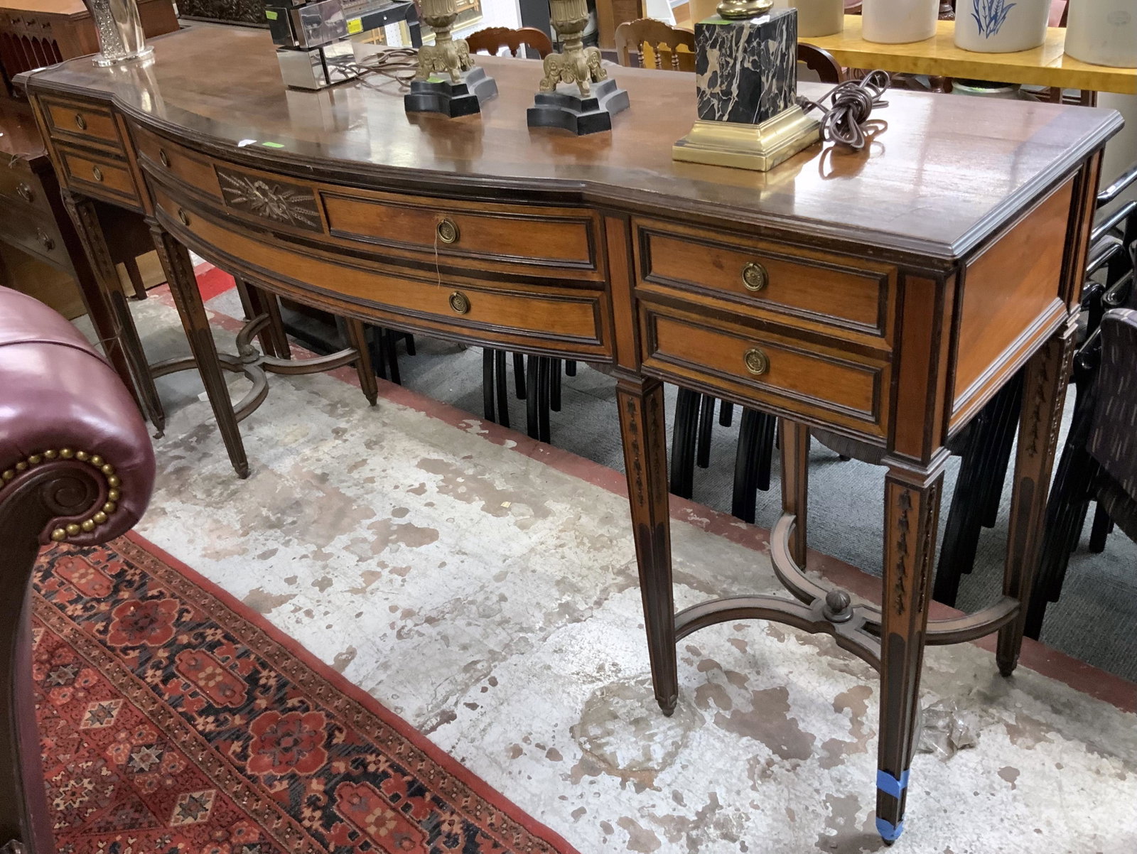 Long Sheridan Style Sideboard.: This sideboard has 6 doors on tall legs, Brass Hardware, and applied carving. There is Minor repainting on the right front leg. The Sideboard Measures 87" Wide, 23" Deep x 39" Tall. Third-party freigh