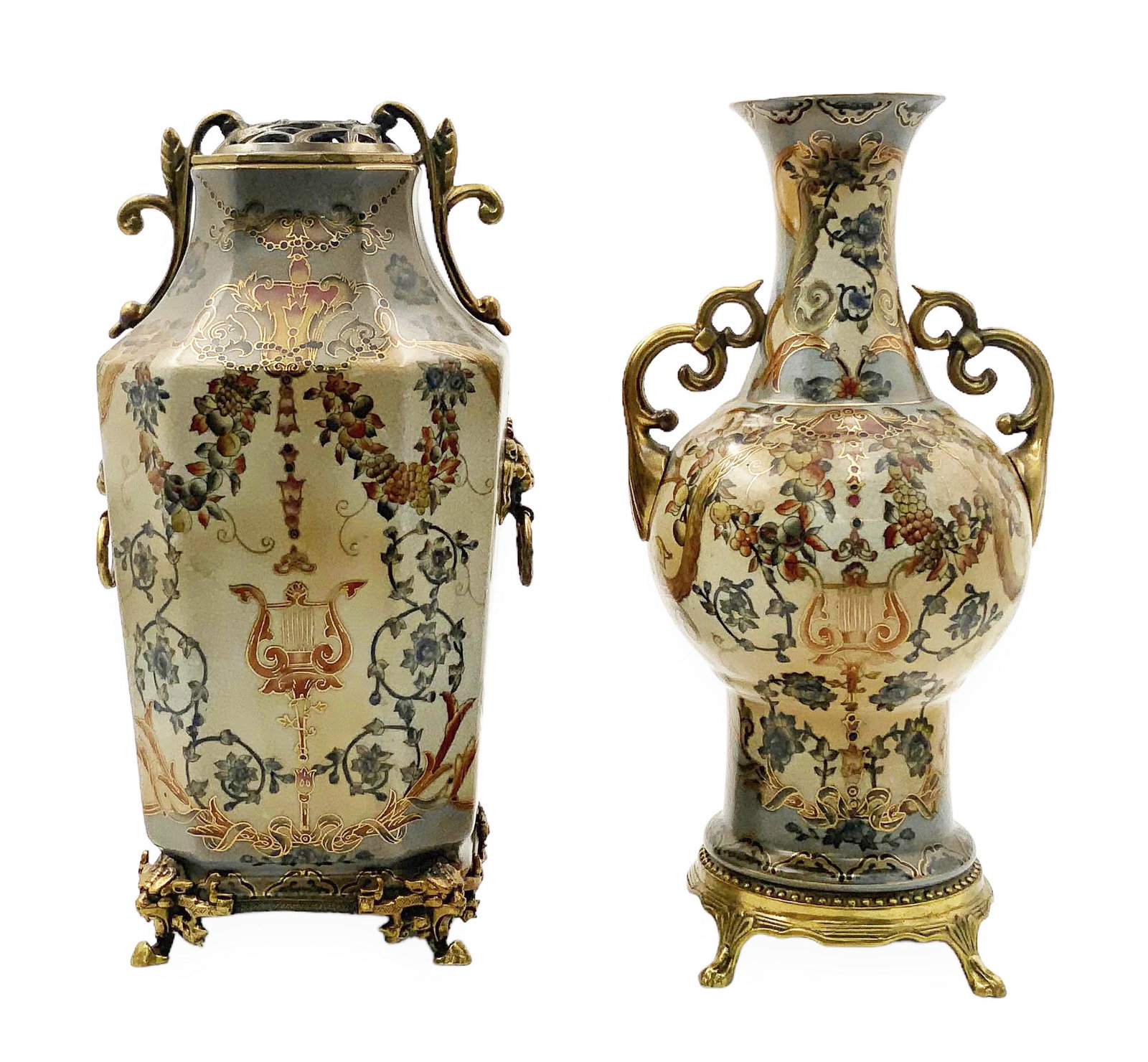 Pr. of Gilded Dominic Porcelain Vases.: This pair of vases have brass ornamentation and gilding. They both depict floral motifs surrounding a harp. Both are marked on their undersides. The larger vase has lion head handles. Each vase has cr