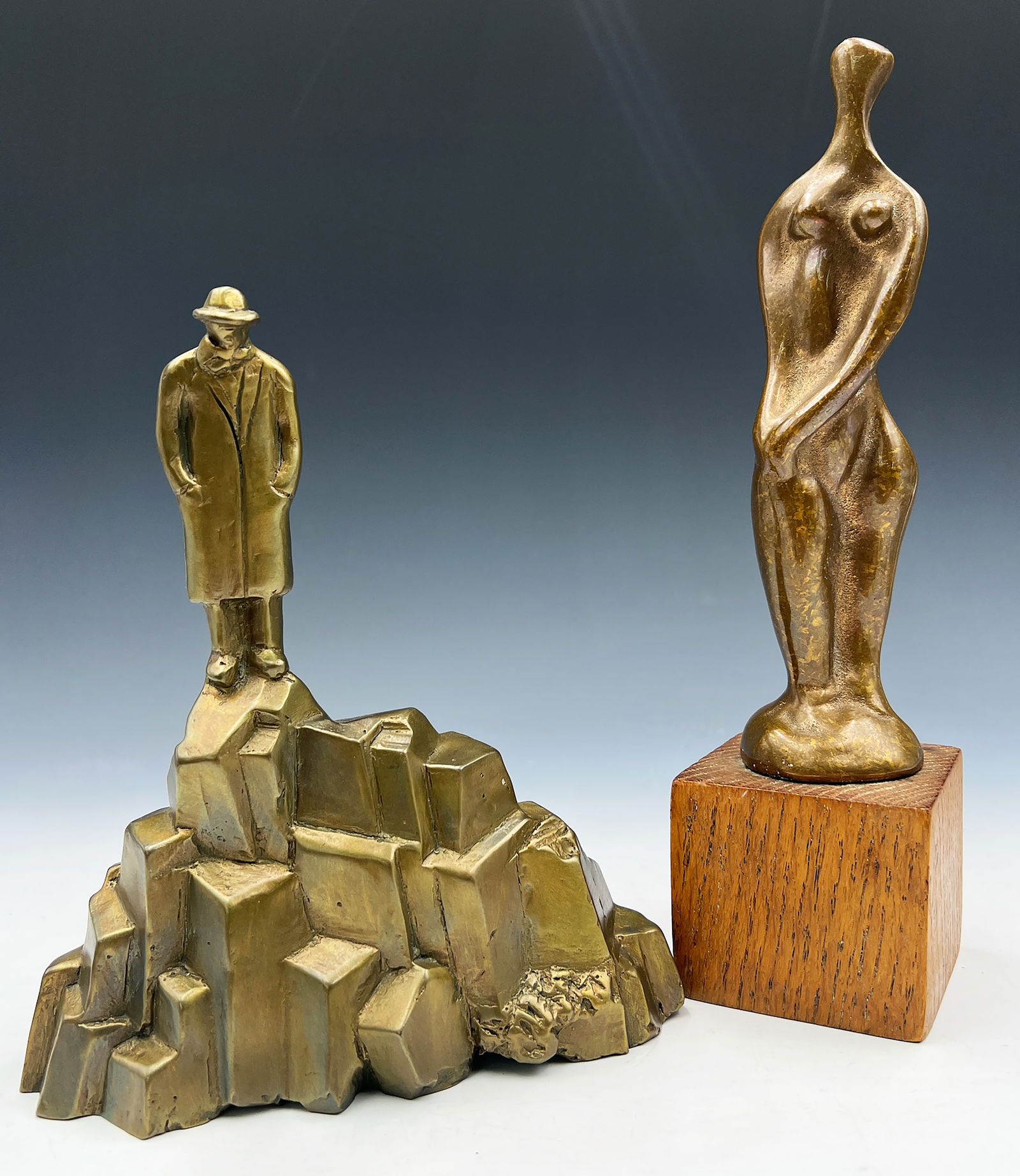 Lot of 2 Bronze Sculptures.: This lot contains two small bronze sculptures. One is of a man looking down at a cliffside, likely by Siegfried Neuenhausen (German, b. 1931). It is numbered 32/60, and is unsigned. The other is an ab