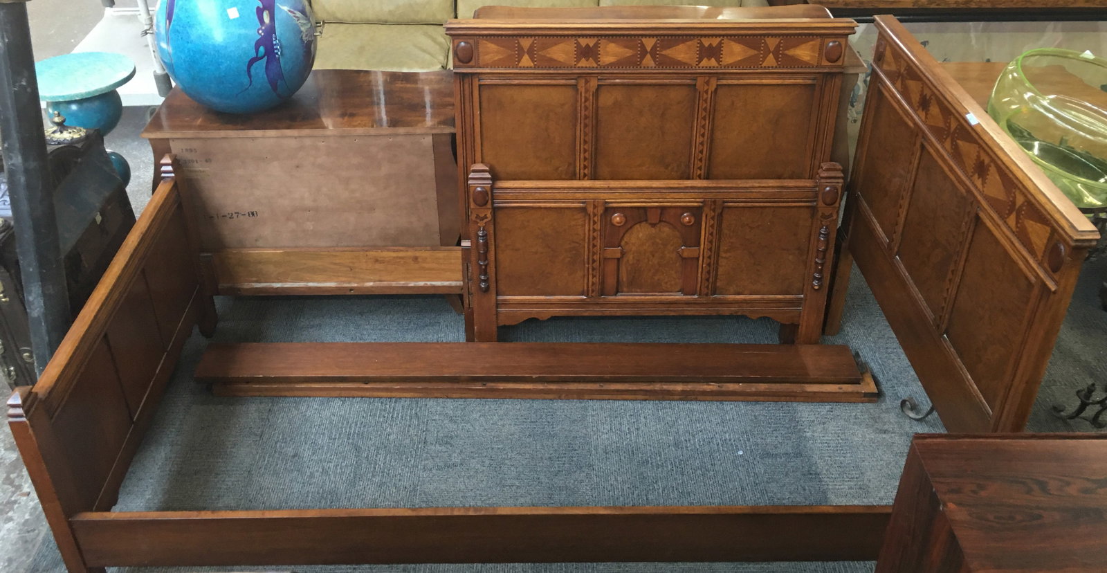 Pair of Burled and Inlaid Twin Beds.: This is a fine pair of Berkey & Gay burled and inlaid oak twin beds with raised wood decorations. Both beds have four wood slats each. There are minor scratches on the pieces, and the top of one of th
