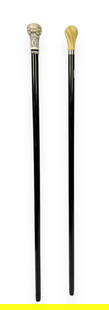 Lot of Two Canes or Walking Sticks.: The first cane is a signed Gucci ebonized walking stick with a resin top. It is marked "Gucci / Made in Italy" on a small plaque near the handle. The bottom of the cane is slightly chipped, but condit