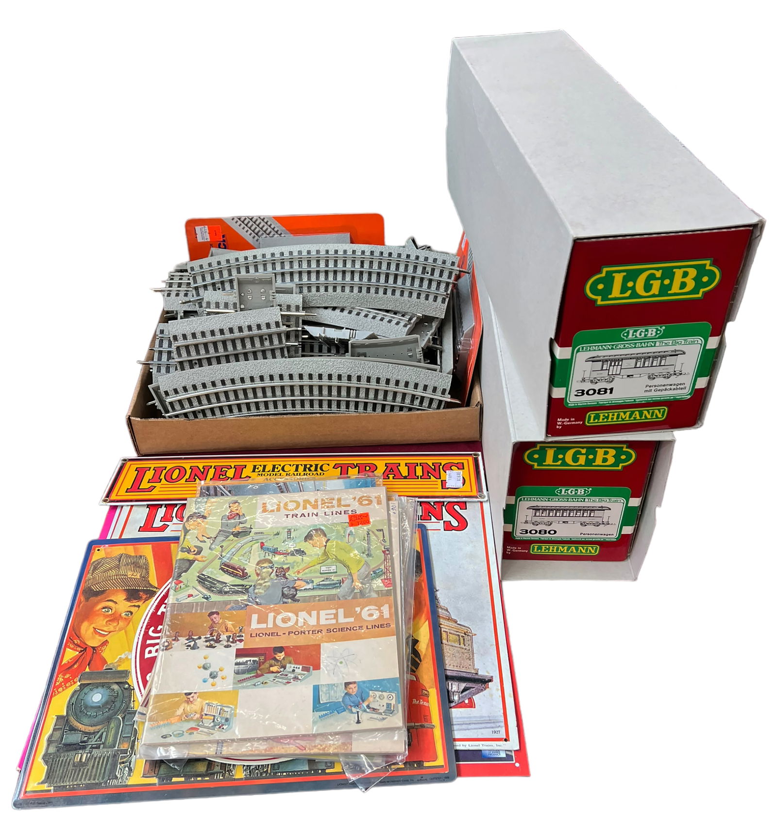 Lot of LGB Trains & Lionel Accessories.: The two LGB trains are a Passenger car with luggage compartment (#3081) and another passenger car (#3080). There is a wide assortment of Lionel tracks, metal wall hangings, and vintage magazines. The