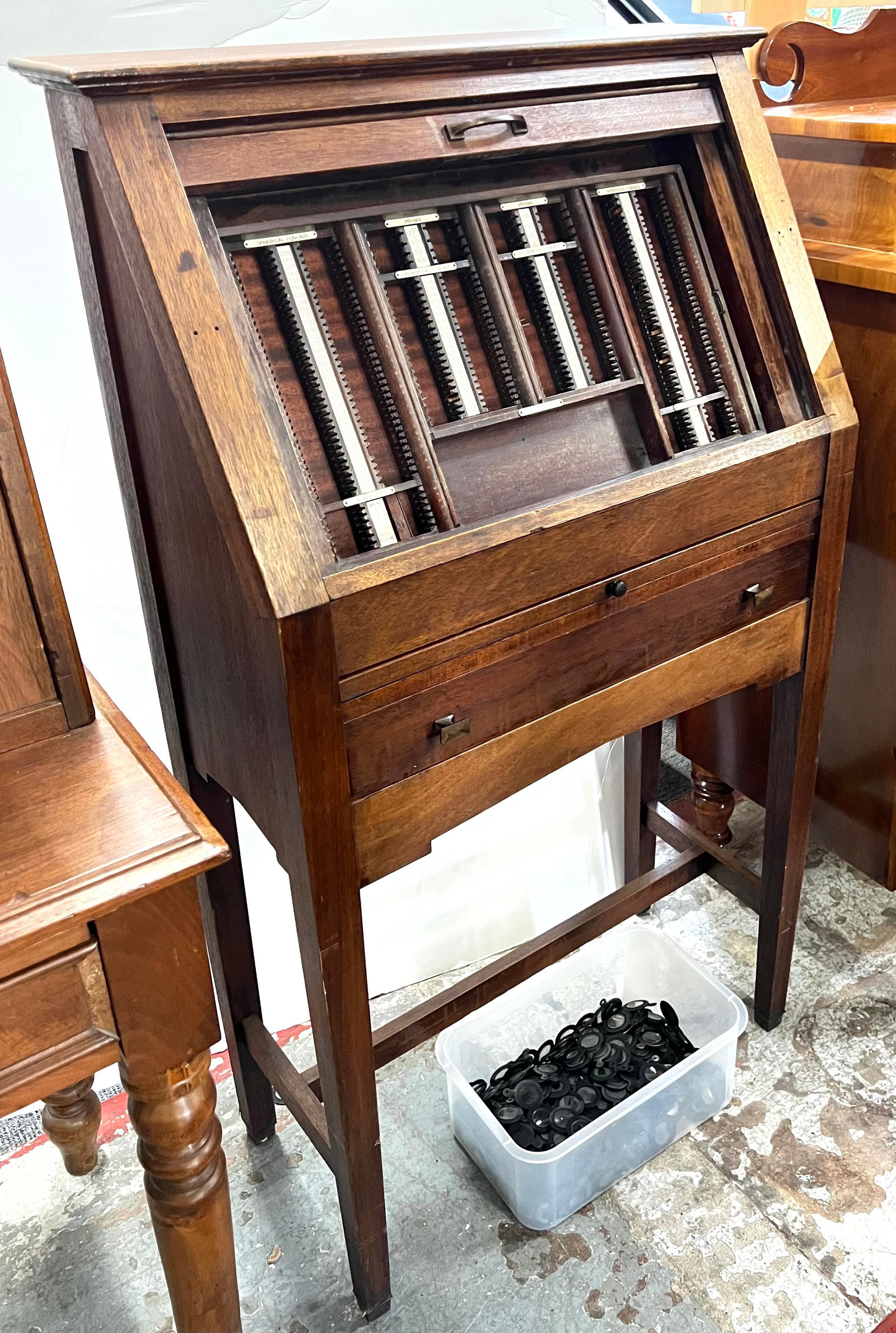 Antique Optometrist Cabinet.: This antique optometrist cabinet also comes with many lenses and a variety of instruments. The cabinet features a tambour door that opens up to a fitted interior for the storage and display of the len