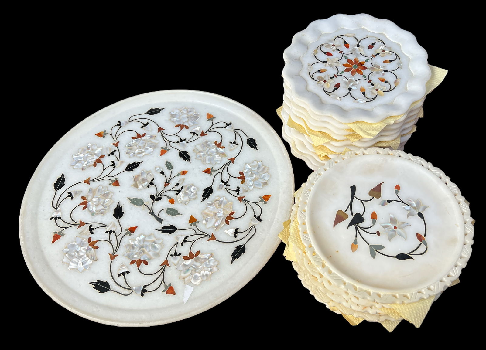 Set of 21 Pietra Dura Floral Alabaster Plates.: The lot includes ten 7" plates with wavy rims, ten 7" plates with carved and pierced rims, and a large platter. The large platter measures 13 3/4" in diameter. Third-party shipping or personal pickup