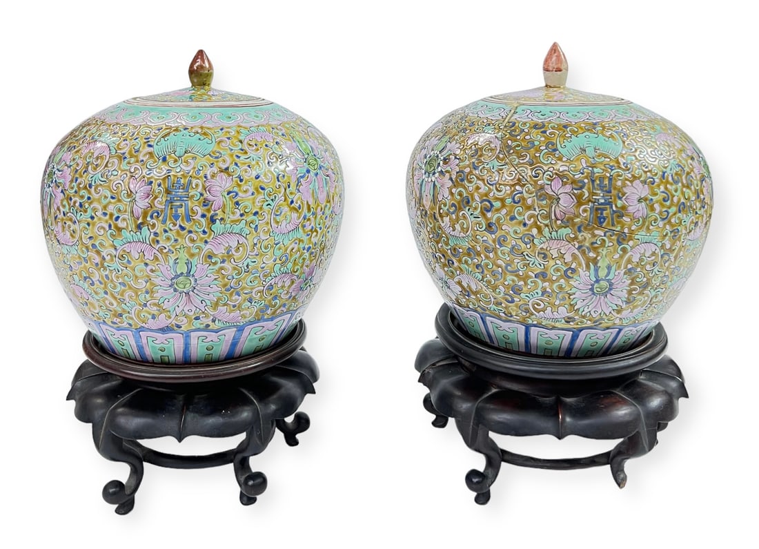 Matched Pair of Chinese Porcelain Covered Jars.: One of them has been badly Damaged and Repaired. The Jars match, but the lids do not match. They both rest on wooden stands, one of which is cracked. The jars measure 8 3/4" tall and 8" in Diameter. T