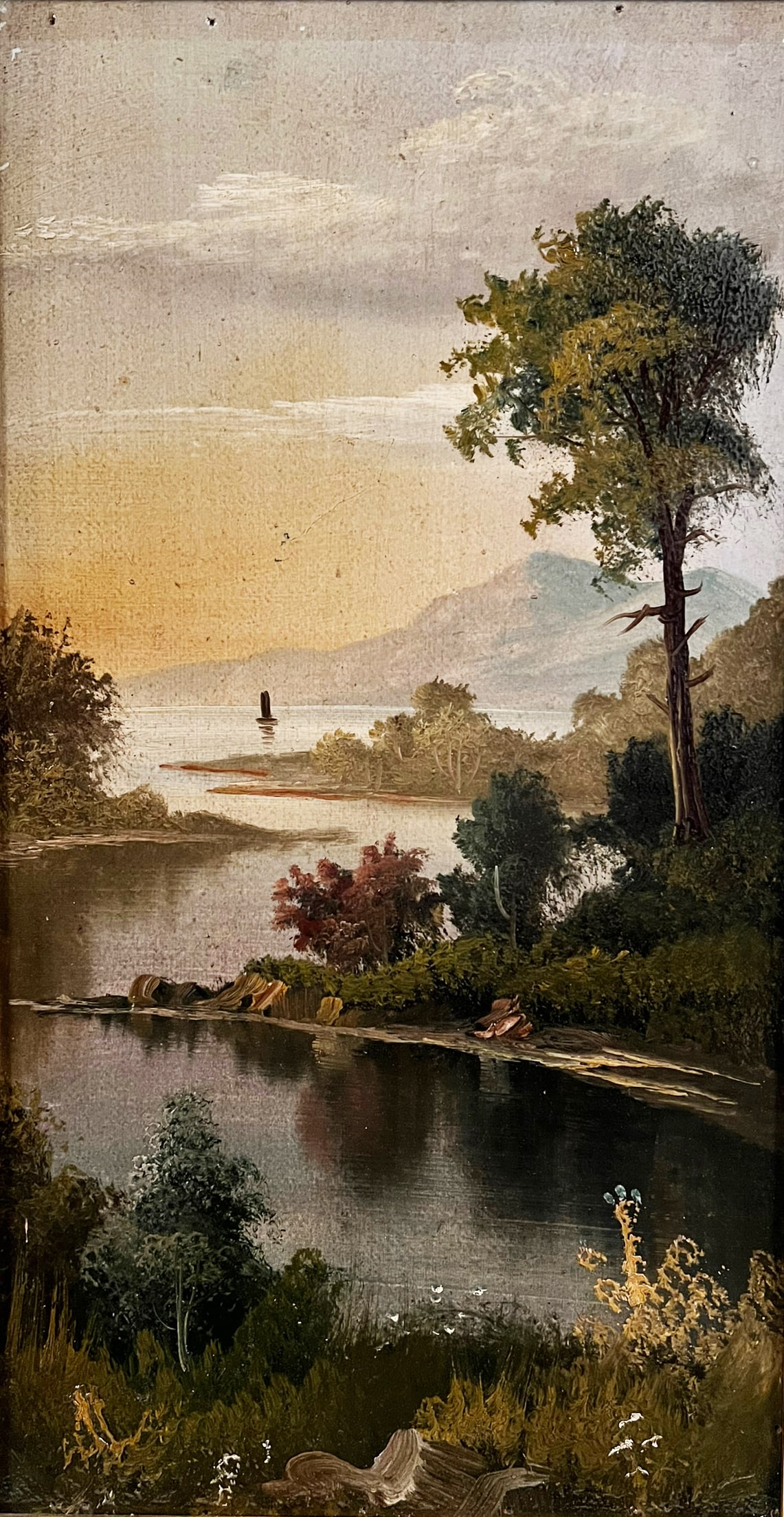 19th Century American School Landscape Painting.: This oil painting on board is unsigned. It shows the Hudson River at dusk. It is housed in a rugged gilt frame. The painting has darkened varnish, perforations to the upper left border, and a scratch 