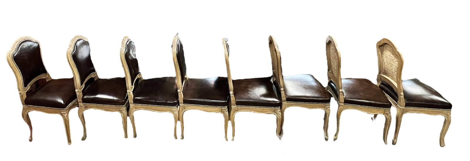 Set of Eight French Style Dining Chairs.: This is a set of eight French style dining chairs with leather seats (possibly faux) and nailhead trim. One of the chairs has two slash marks, but otherwise the set is in good condition with minor sur
