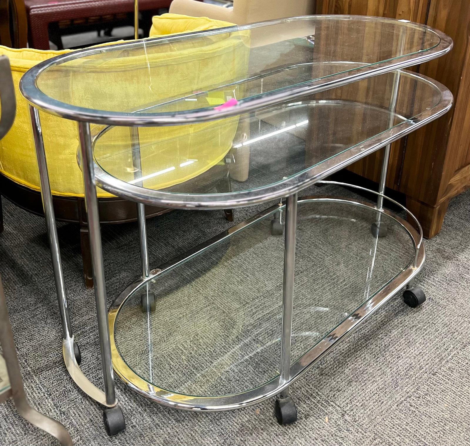 Italian Chrome Bar Cart.: This chrome and glass bar cart is three-tiered, with the lower section able to rotate 360 degrees. The cart can be extended when completely opened. It sits on casters. It is in very good used conditio
