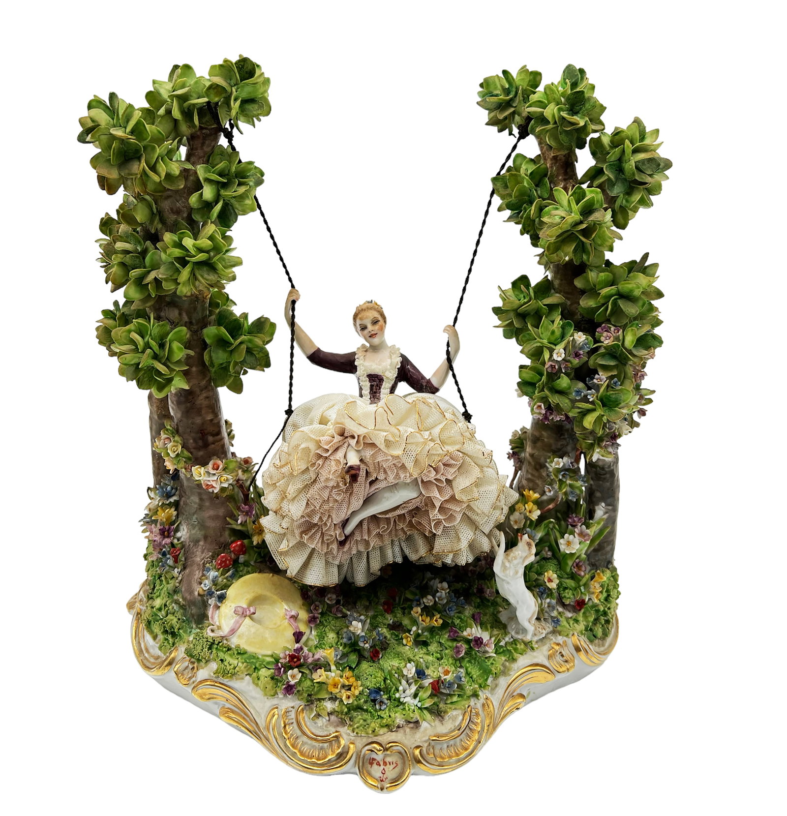 Signed Fabris Porcelain Group of Woman on Swing.: The figure is of a young lady with a full lacy dress, kicking up a foot while she swings among trees and flowers. On one side of her, a spring hat lies in the grass. On her other side, a little dog st
