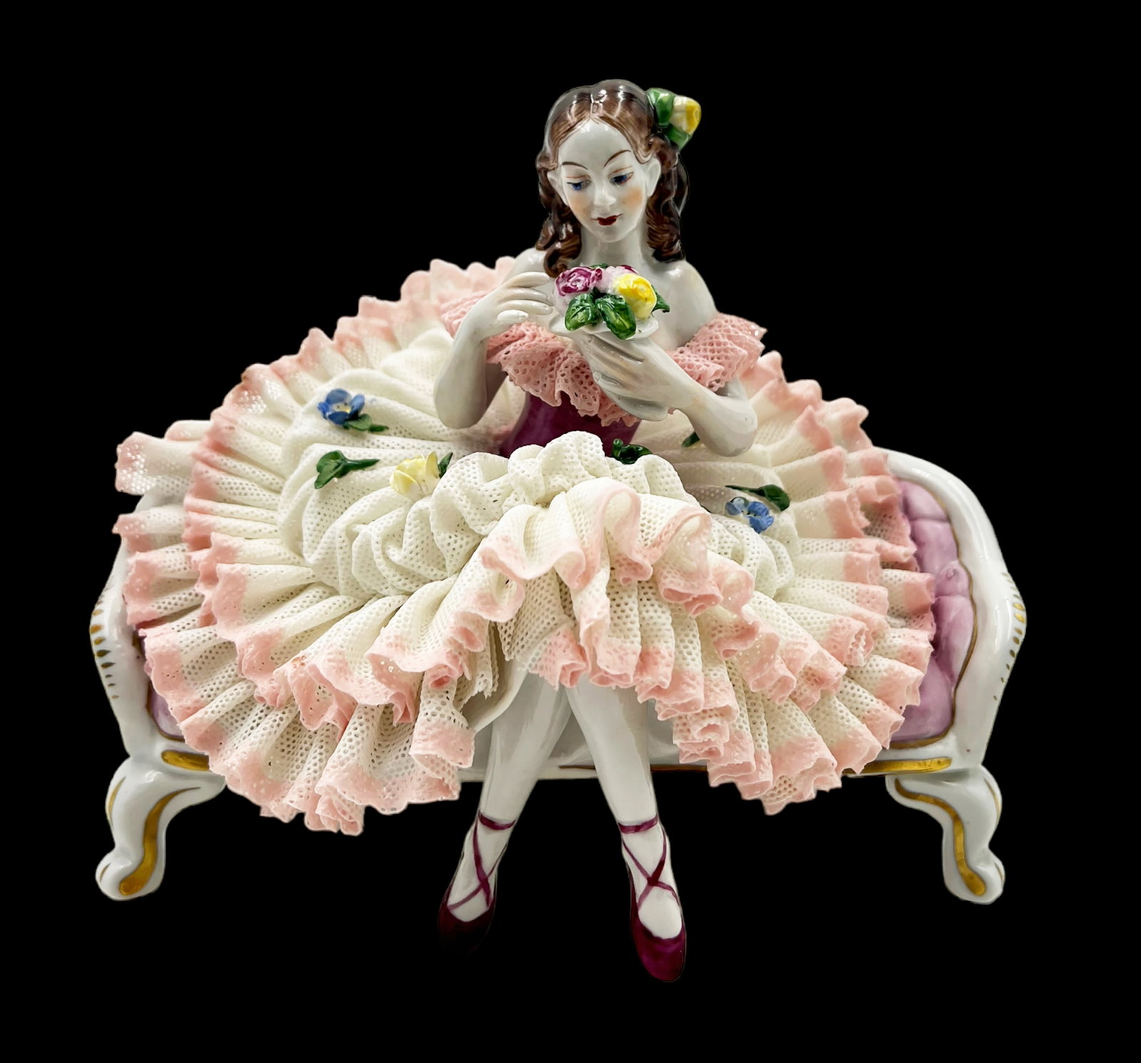 Volkstedt Lace Figurine of Woman w/ Flowers.: The figure is of a woman seated on a sofa, with her full lace skirt taking up the entirety of the couch. There are Some areas of lace loss. Its Measurements are 6 3/4" x 5" x 6". Third-Party Shipping 