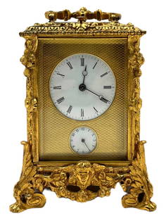 Ornate Gilt Bronze Carriage Clock w/ Alarm.: The key is included. The clock is highly Decorated, with four paw feet and a man's head under the dials. It Looks to be in Very Nice cosmetic condition, but its working condition is not known. Its Mea