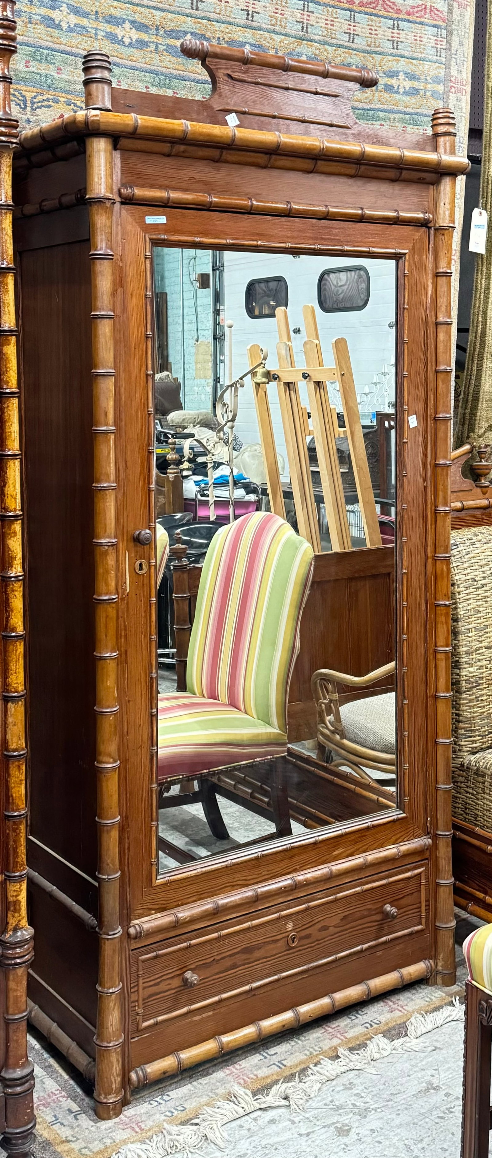 Antique Faux Bamboo Armoire.: This is a Victorian faux bamboo varnished armoire made of pine. It has a removable decorative top, as well as a mirrored bevelled glass door with a storage area inside (all the shelves are missing). T