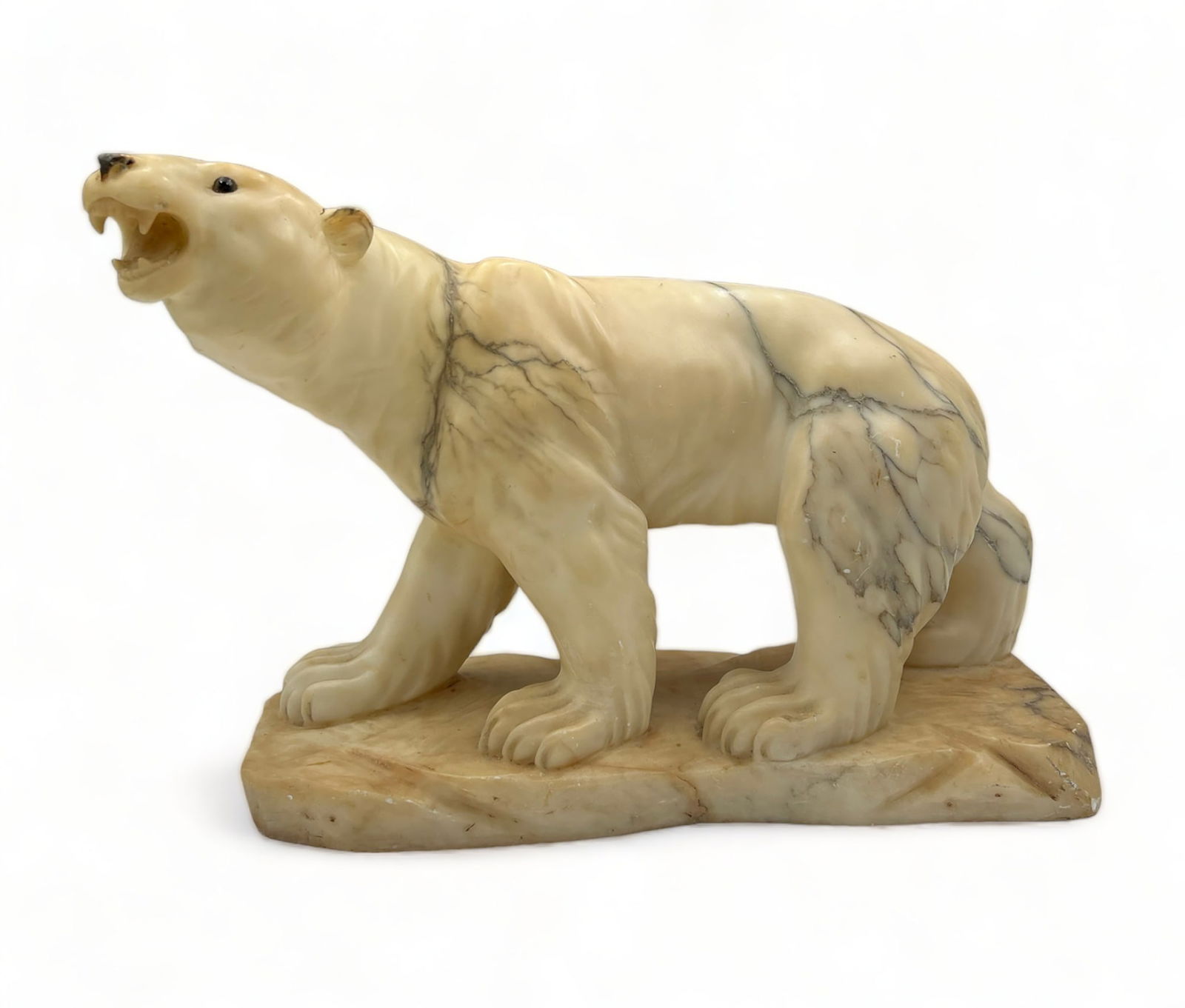 Old Carved Alabaster Polar Bear Sculpture.: This statue is unsigned. It depicts an astride polar boar with its mouth open. The eyes appear to be glass, and the nose is painted. The number "33" is carved into the base. The statue measures 17" x