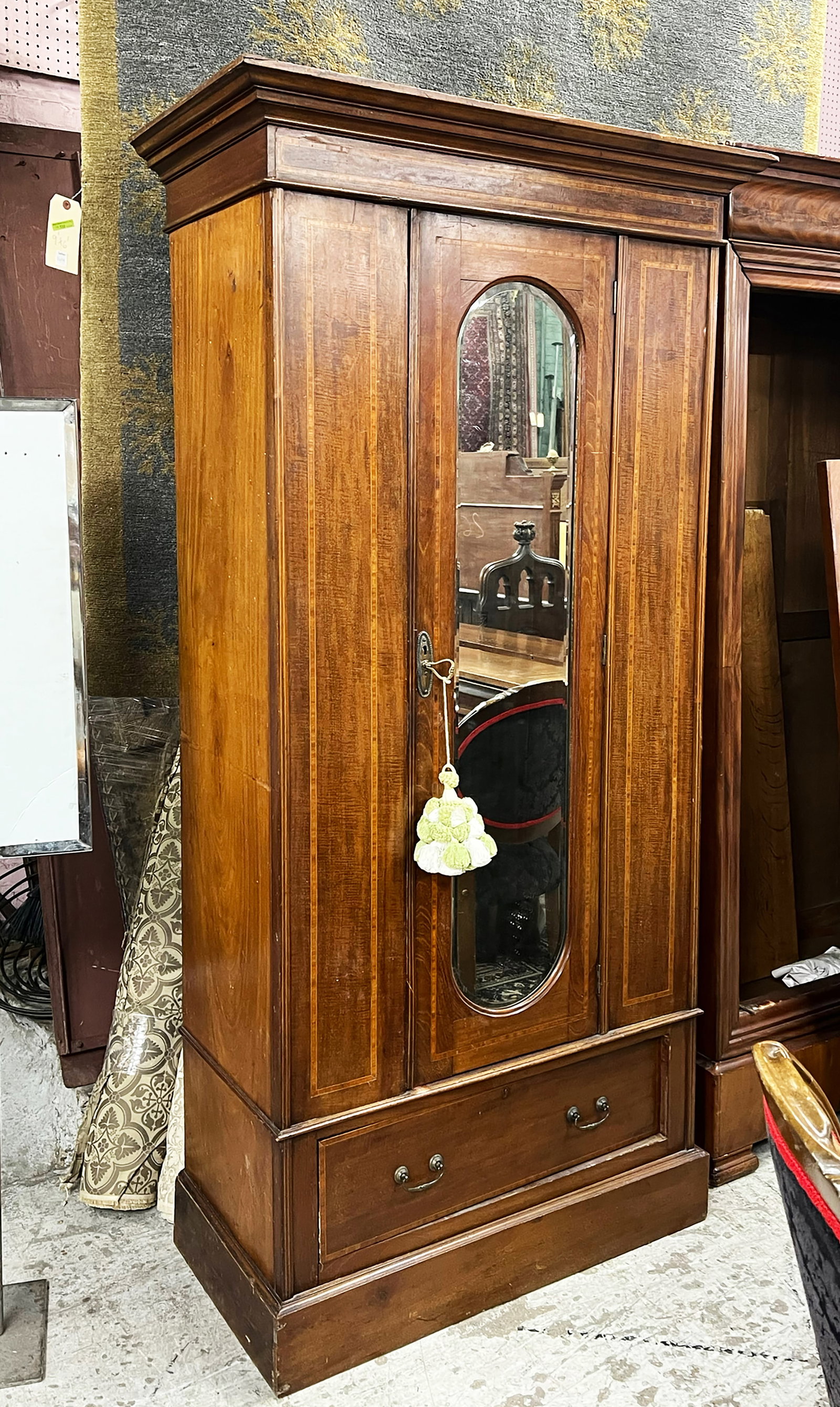 Banded and Inlaid Wardrobe.: The mirror glass is bevelled. Inside the wardrobe there are seven brass hooks. There is also a bottom drawer with brass hardware. The piece is in used condition, with some scratches and chips. It meas