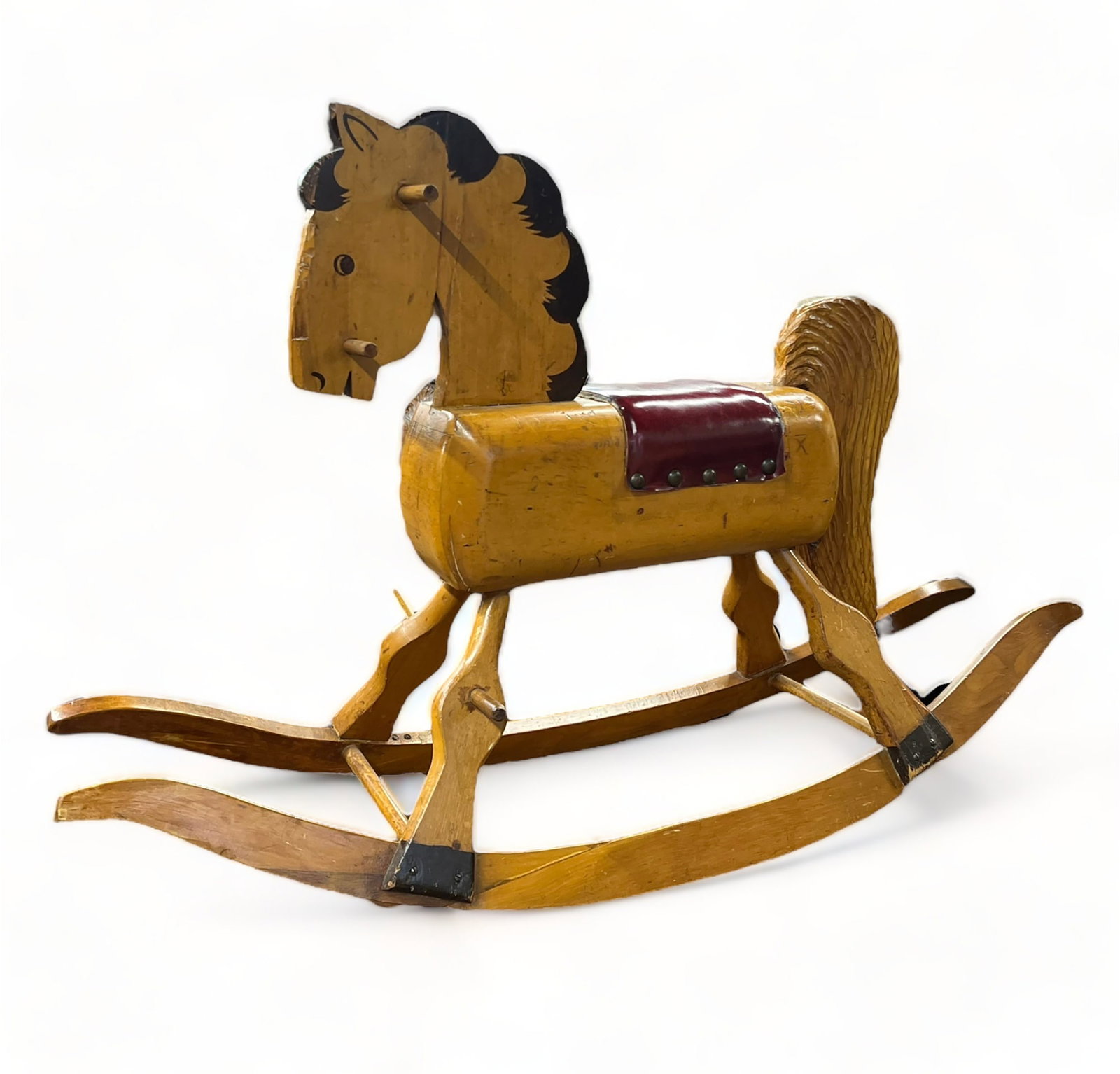 Vintage Child's Rocking Horse.: This is a carved wood rocking horse with a red leather seat. The tail is removable. It is in vintage condition, with some paint loss and cracks. It measures 30" wide, 12" deep, and 32" tall. The platf