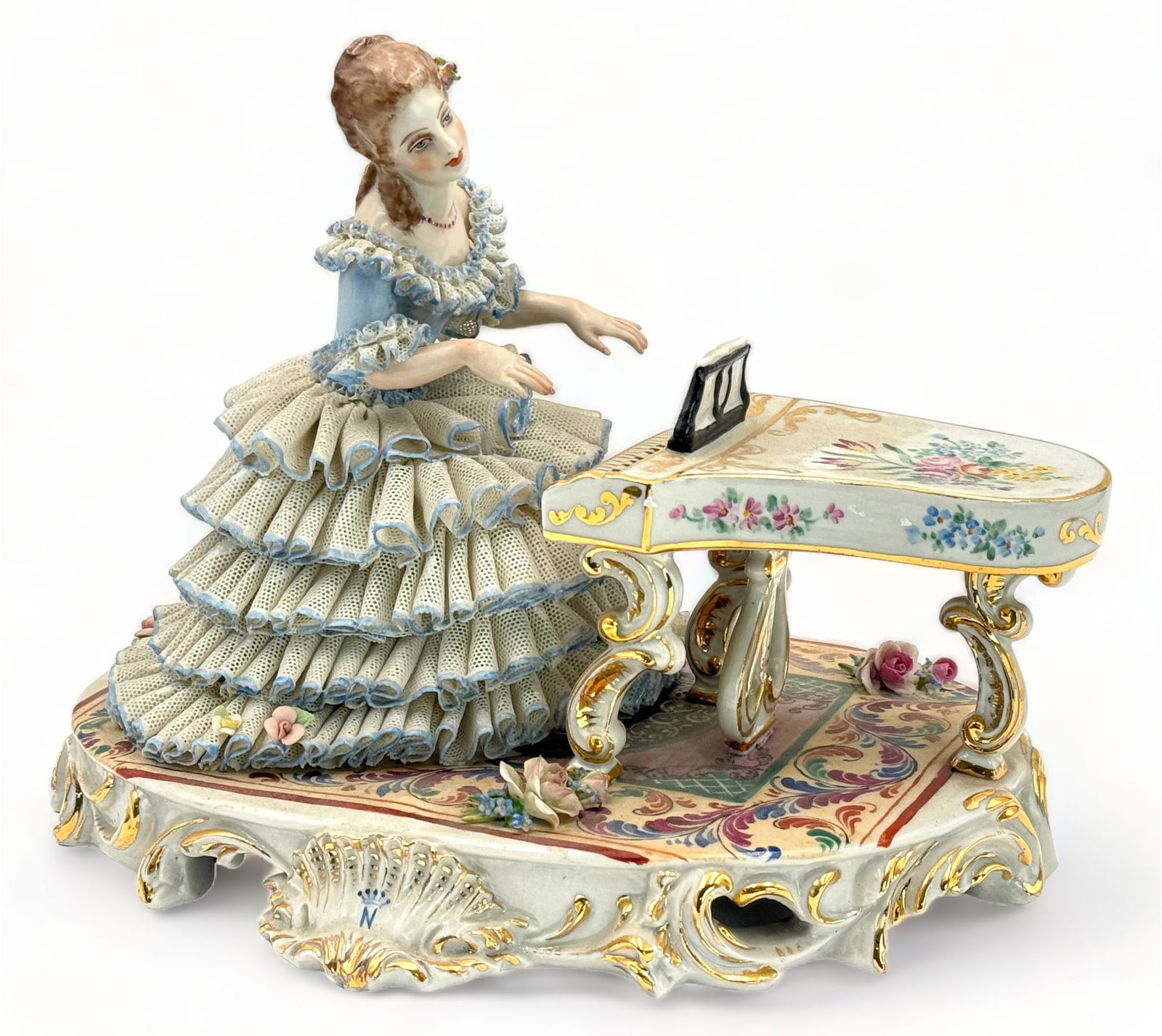 Lace Figure of Woman at Piano.: The figurine is Marked, "Made in Italy", with a blue "N" under a 5-pointed crown. The figure could use a Cleaning, but looks to be in overall Good condition. There are some small Chips on both the lac