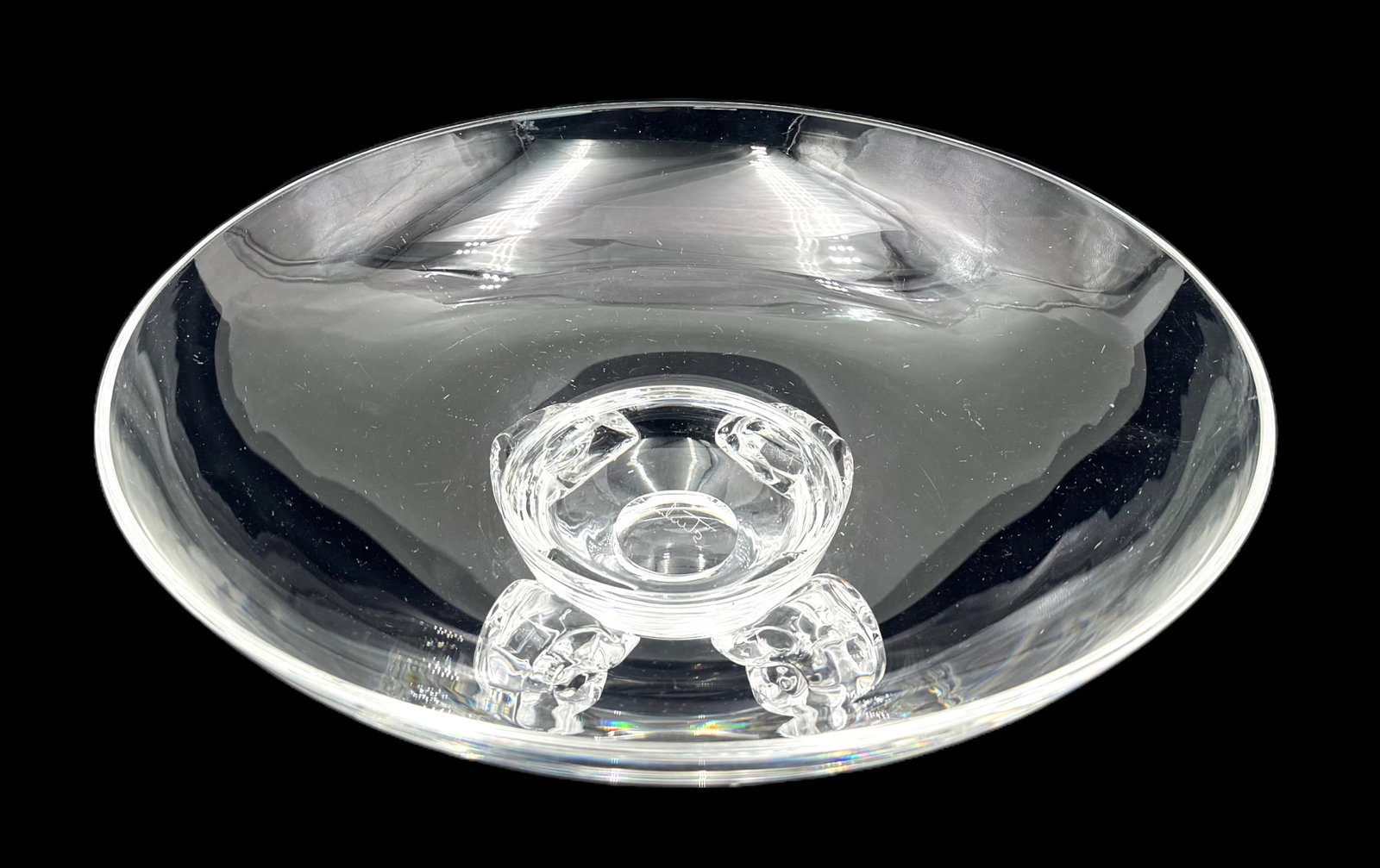 Steuben Crystal Center Bowl w/ Scrolled Feet.: It is Signed underneath. There are Some Scratches present; overall, the centerbowl looks to be in Nice cosmetic condition. Its Measurements are 10 5/8" in diameter, and 3 1/2" tall. In-House Shipping 