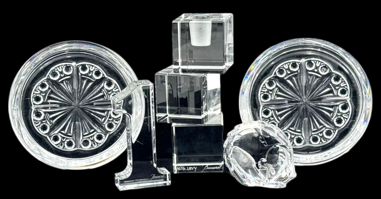 Lot of Baccarat Crystal Pcs.- Arik Levy, etc.: All are Signed. The Arik Levy candlestick resembles three stacked cubes. The lot also includes a hedgehog paperweight, a "1" paperweight (Chipped), and a pair of coasters (one is Chipped). The largest