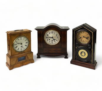 Lot of 3 Antique / Vintage Wood Mantel Clocks.: The light wood clock has a label from J.H.W. Bailey, Clockmaker. This one comes with a Key and Pendulum, and measures 13" tall. The Thin Dark wood clock is by the E. Ingraham & Company. It also has it