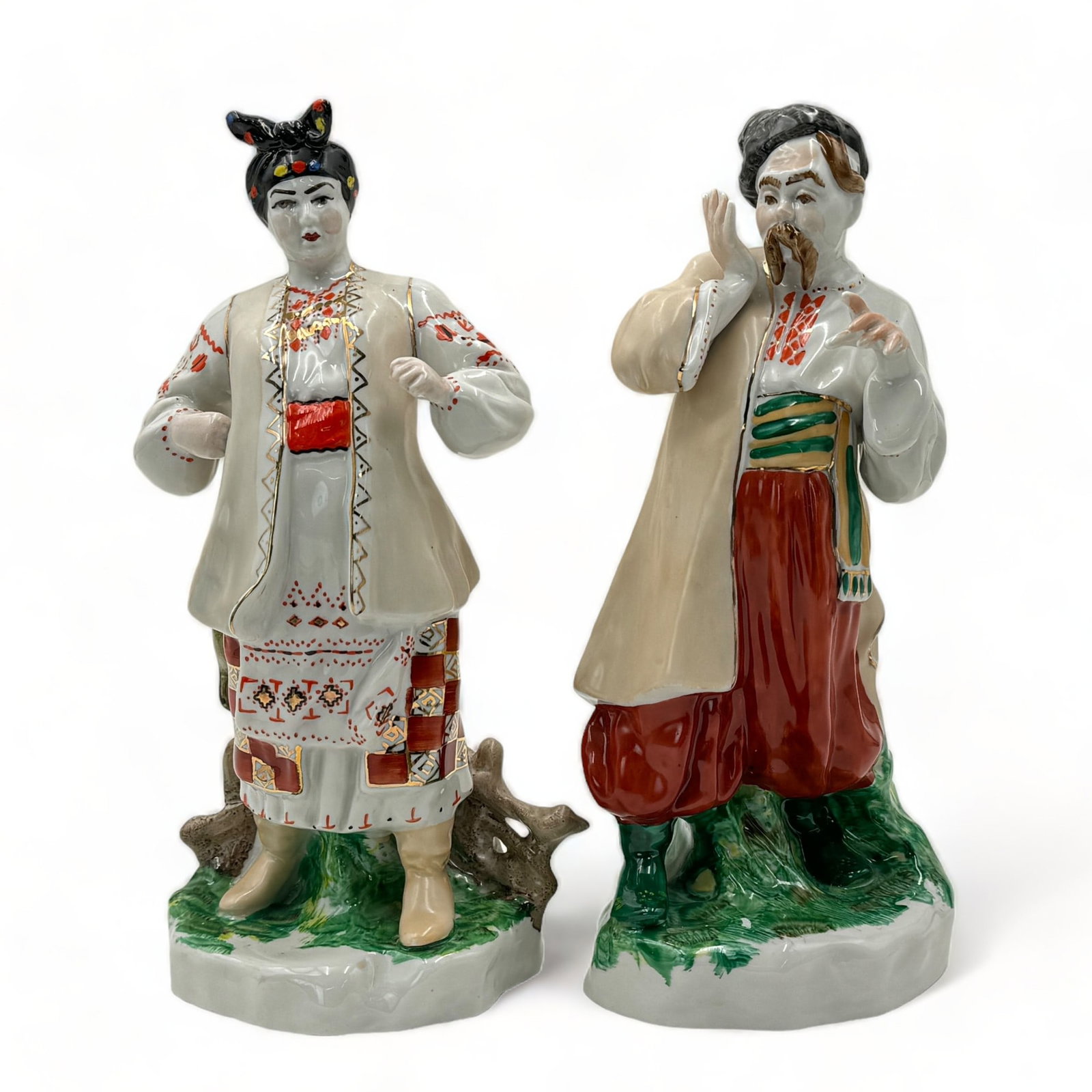Pair of Vintage Soviet Porcelain Figurines.: They are a man and woman, in traditional dress. Each is marked on the underside with a large "K" and the words, "Made in USSR". They are in Nice condition overall. The larger figure measures 10" tall.