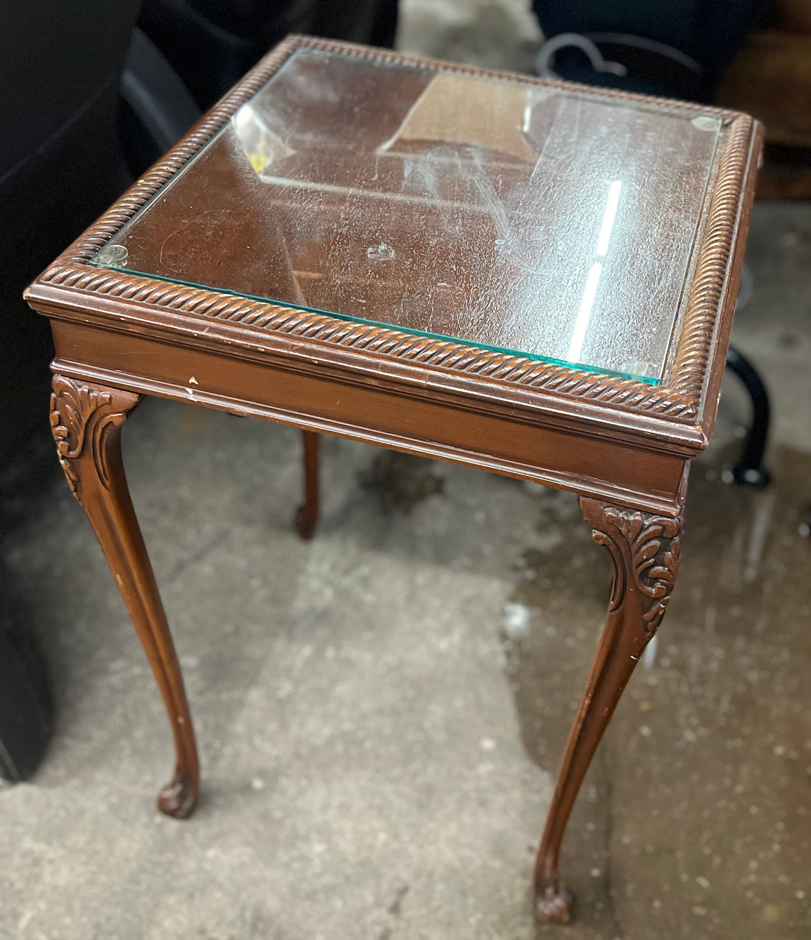 Mahogany Lamp Table.: This lamp or side table has carved cabriole legs, and a glass top with gadrooning around the edges. There is a label on the underside that is half torn off. the piece is in used condition, with many s