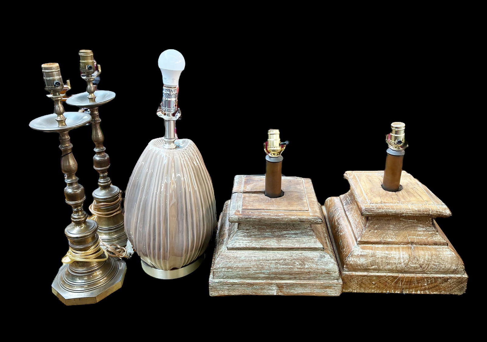 Lot of Five Lamps.: This lot includes a pair of natural wood pedestal lamps, a pair of brass lamps, and a pottery lamp. All of the lamps are missing their harps. They are all in working condition. Third-party freight shi