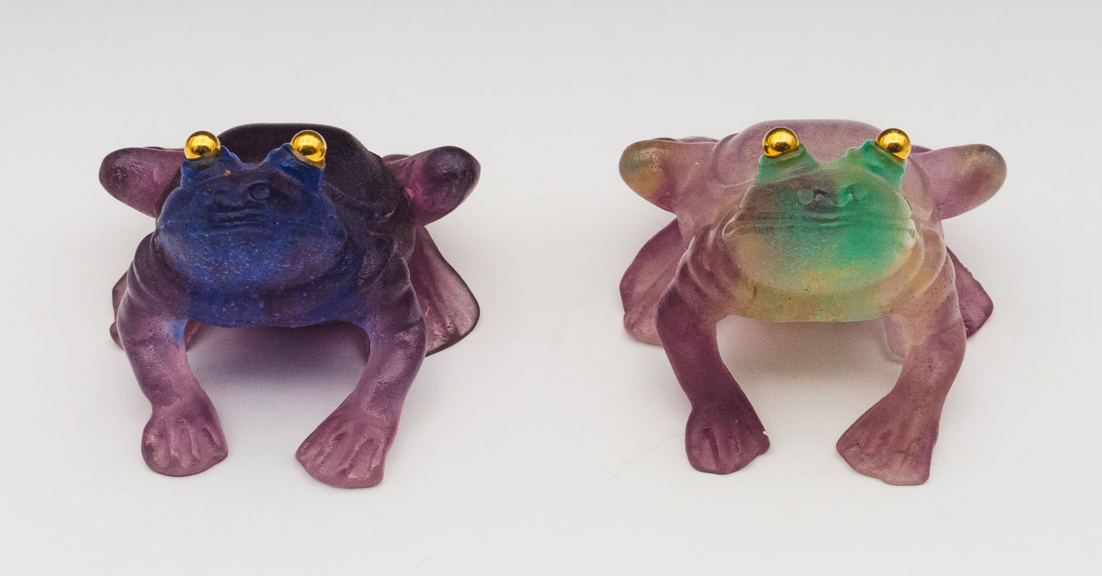 Lot of 2 Daum France Pate de Verre Frogs.: They are identical, apart from their coloring. One has various purple tones; the other has light purple and green tones. Both have gold colored eyes. They are in Very Nice cosmetic condition. Each fro